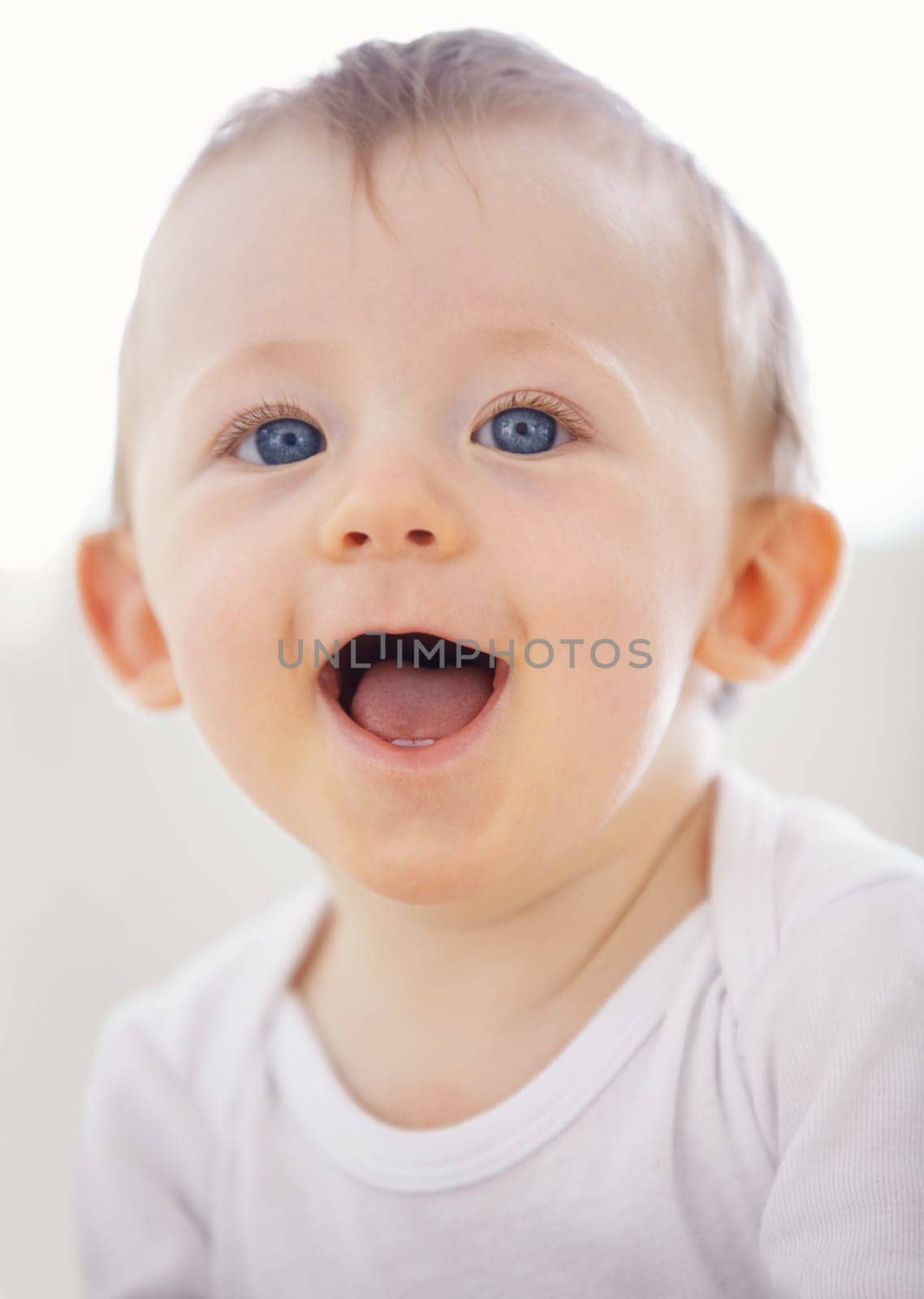 Home, happy and face of baby relax, resting and calm in nursery for sleeping or wake up in morning. Family, youth and closeup of infant newborn in bedroom for child development, growth and wellness.