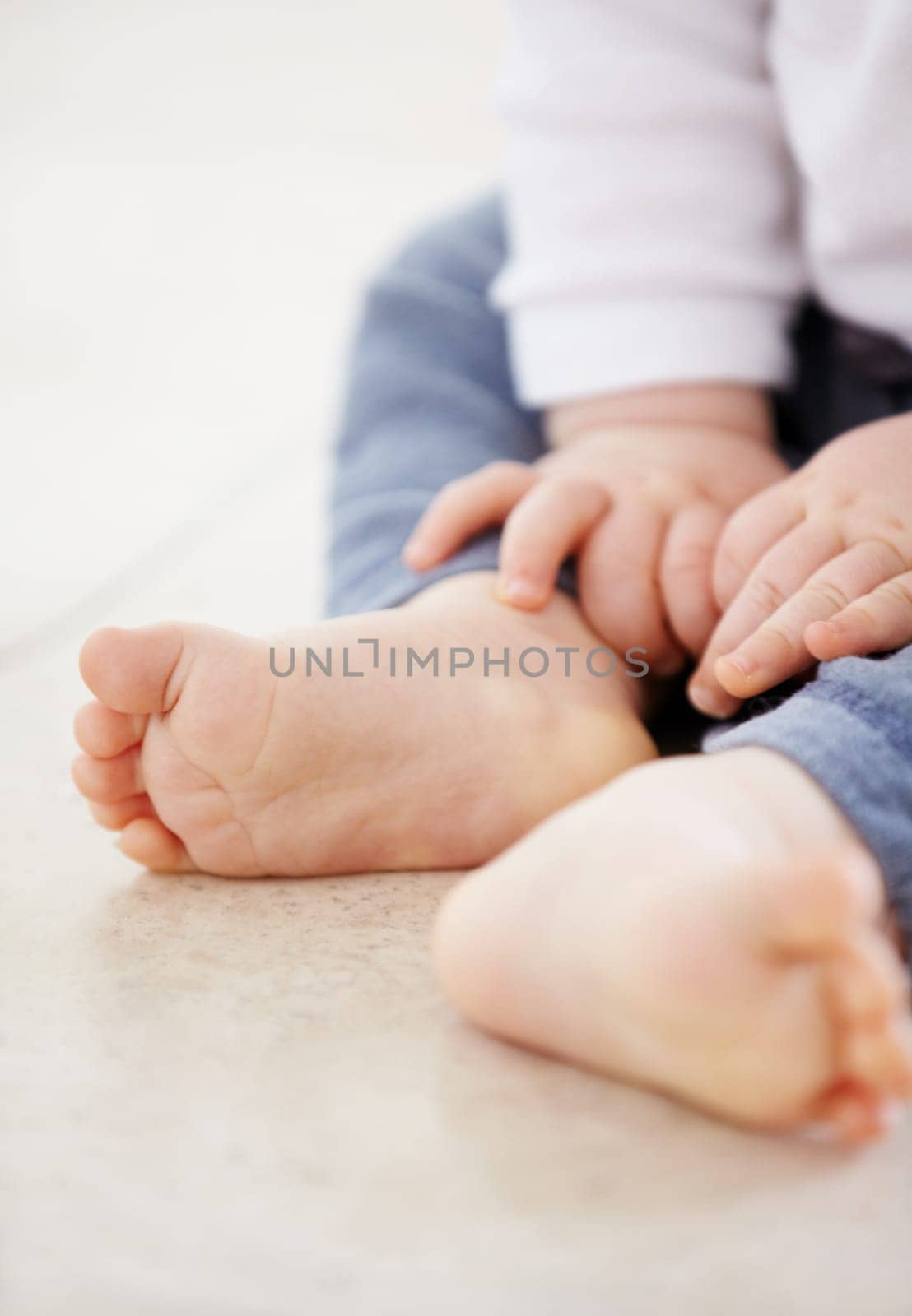Closeup, feet and baby on floor in home for child development, health and growth. Family, youth and adorable toes and hands of young infant in living room for wellness, learning to crawl and relax.