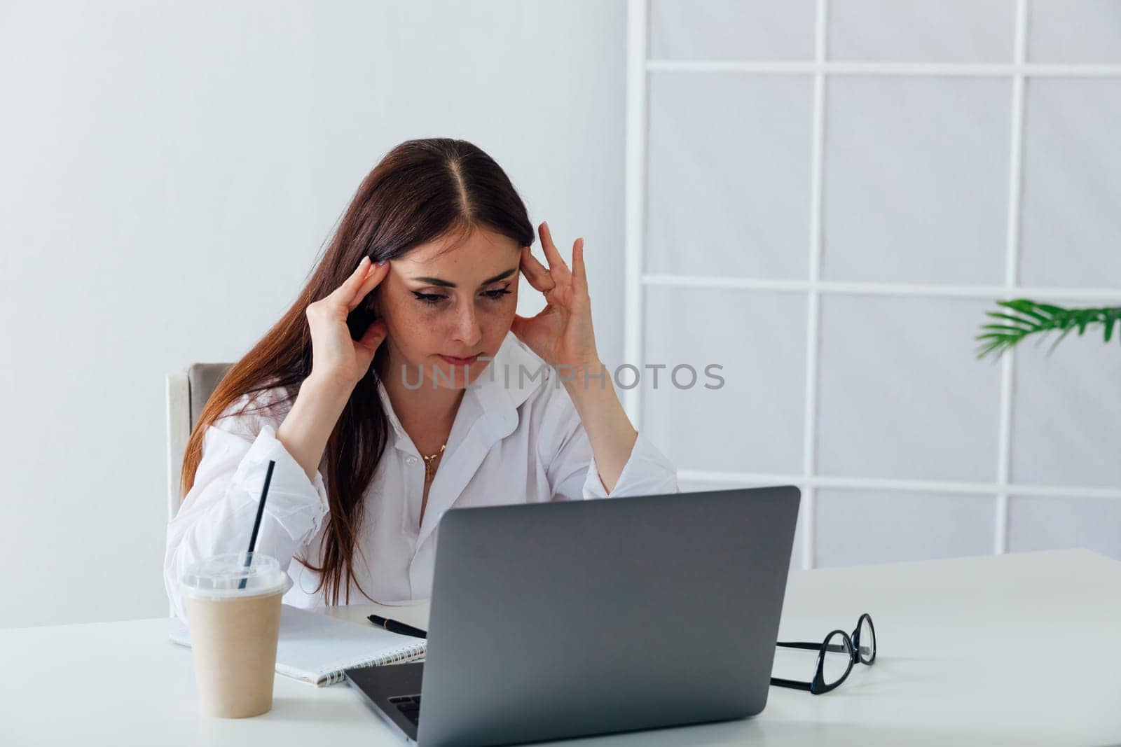 woman tired of working on laptop in office