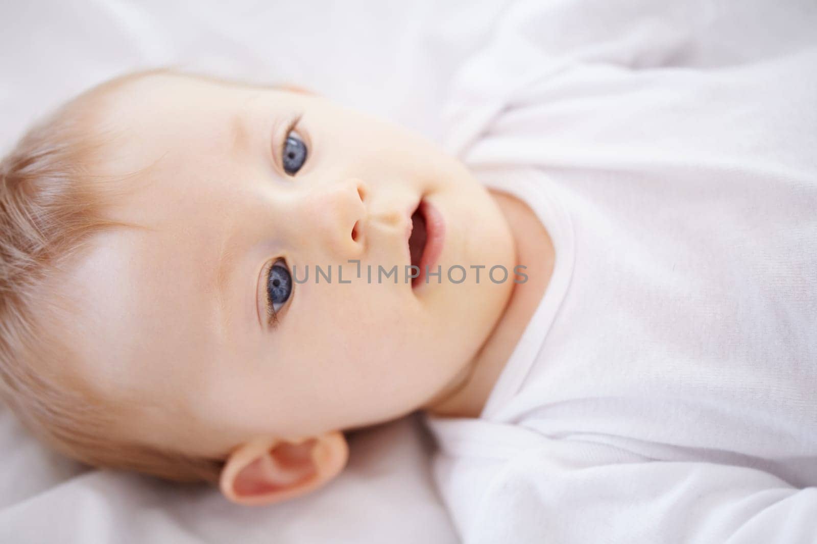 Home, bed and face of baby relax, resting and calm in nursery for sleeping or wake up in morning. Family, youth and closeup of infant newborn in bedroom for child development, growth and wellness.