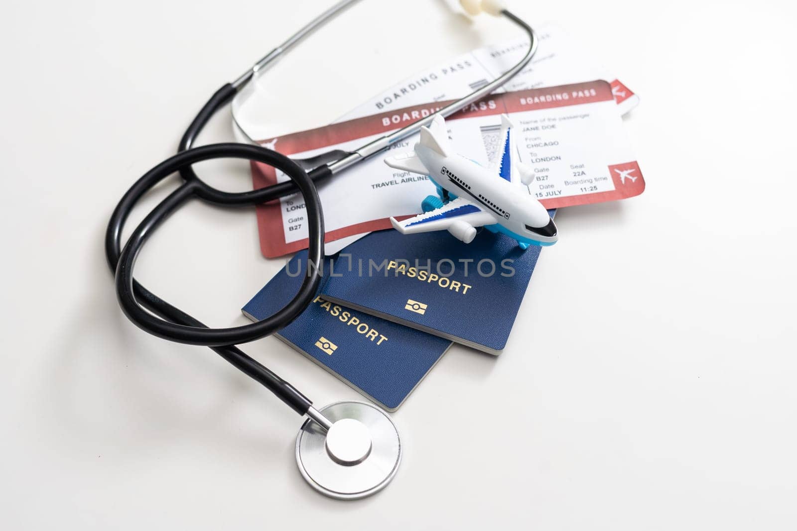 stethoscope, toy airplane on a white background. health insurance on a travel trip by Andelov13