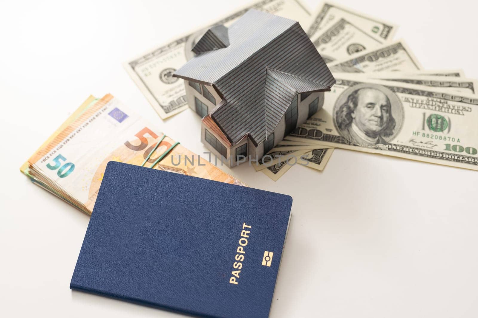 a toy house with banknotes, home insurance, mortgage, a symbol of material well-being.