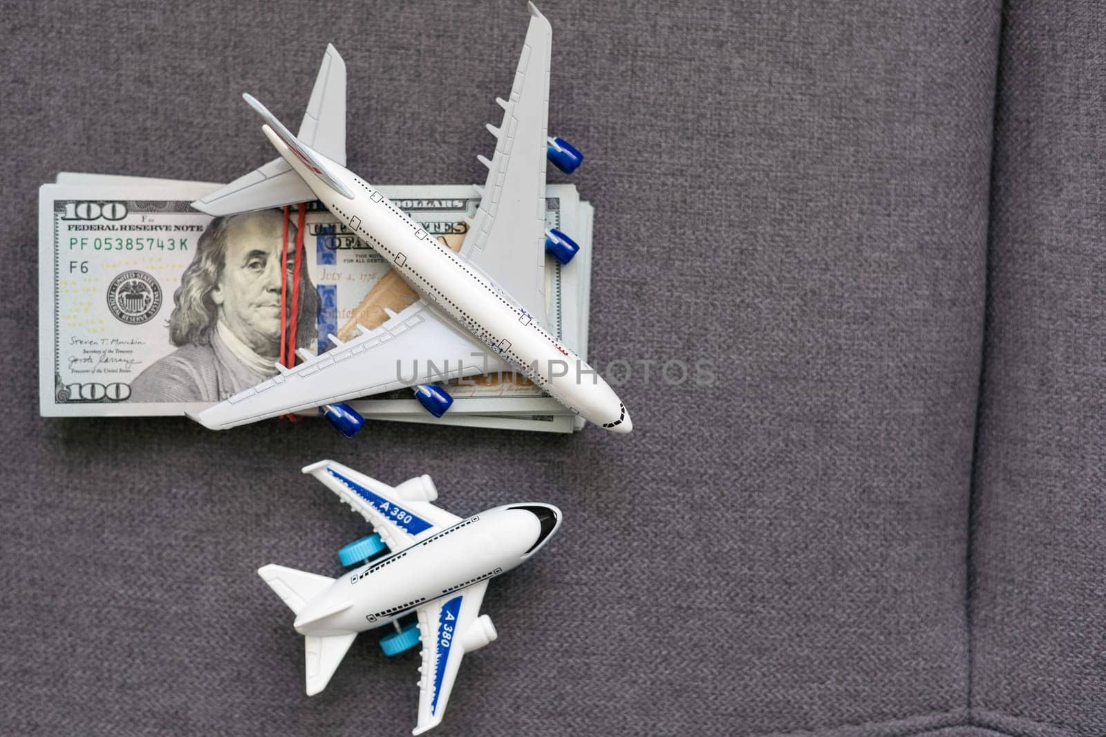 Flatlay picture of toy airplane, fake money by Andelov13