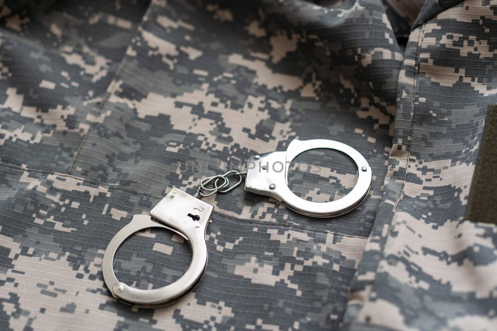 military camouflage uniform, handcuffed on background