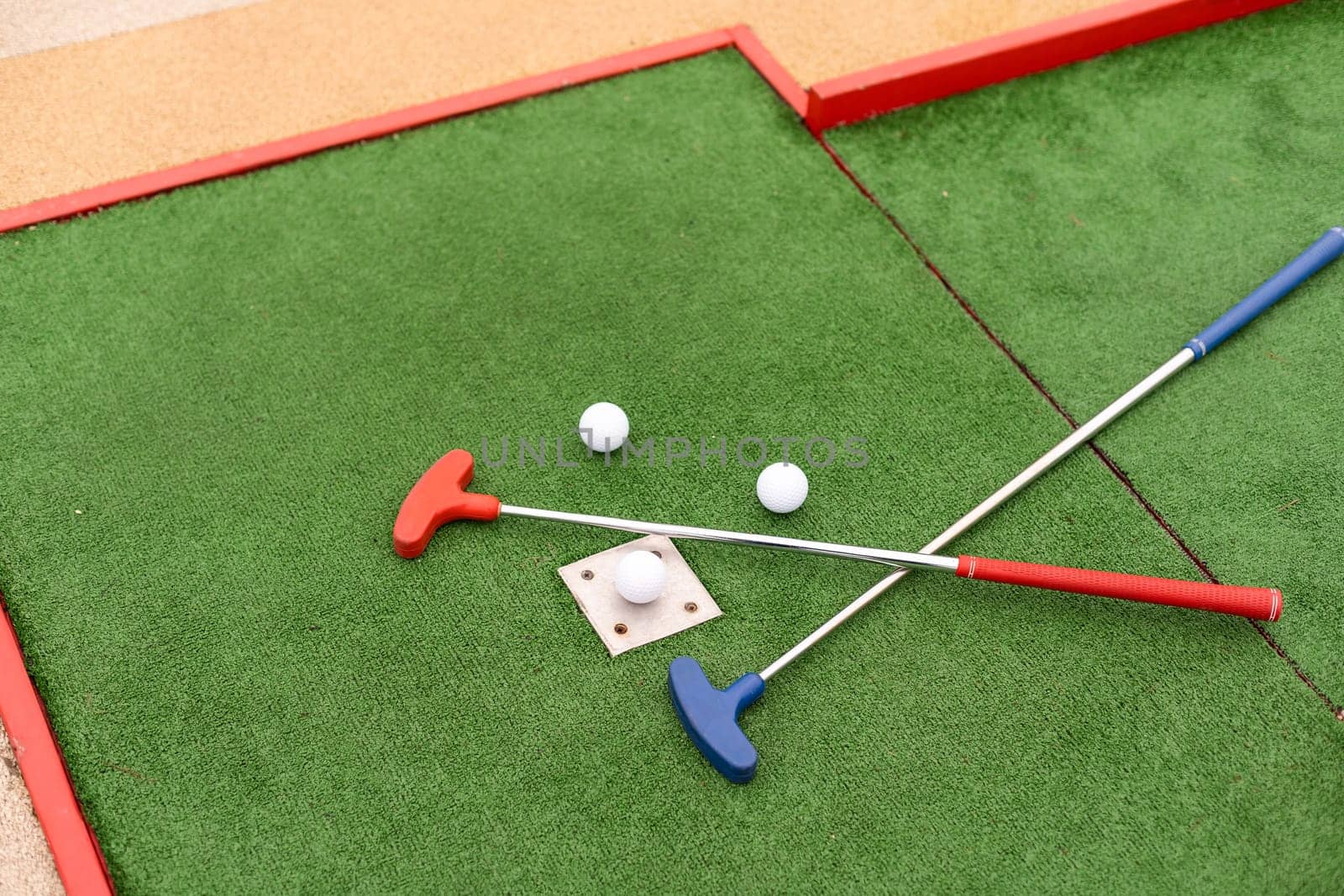 golf club, ball and hole.