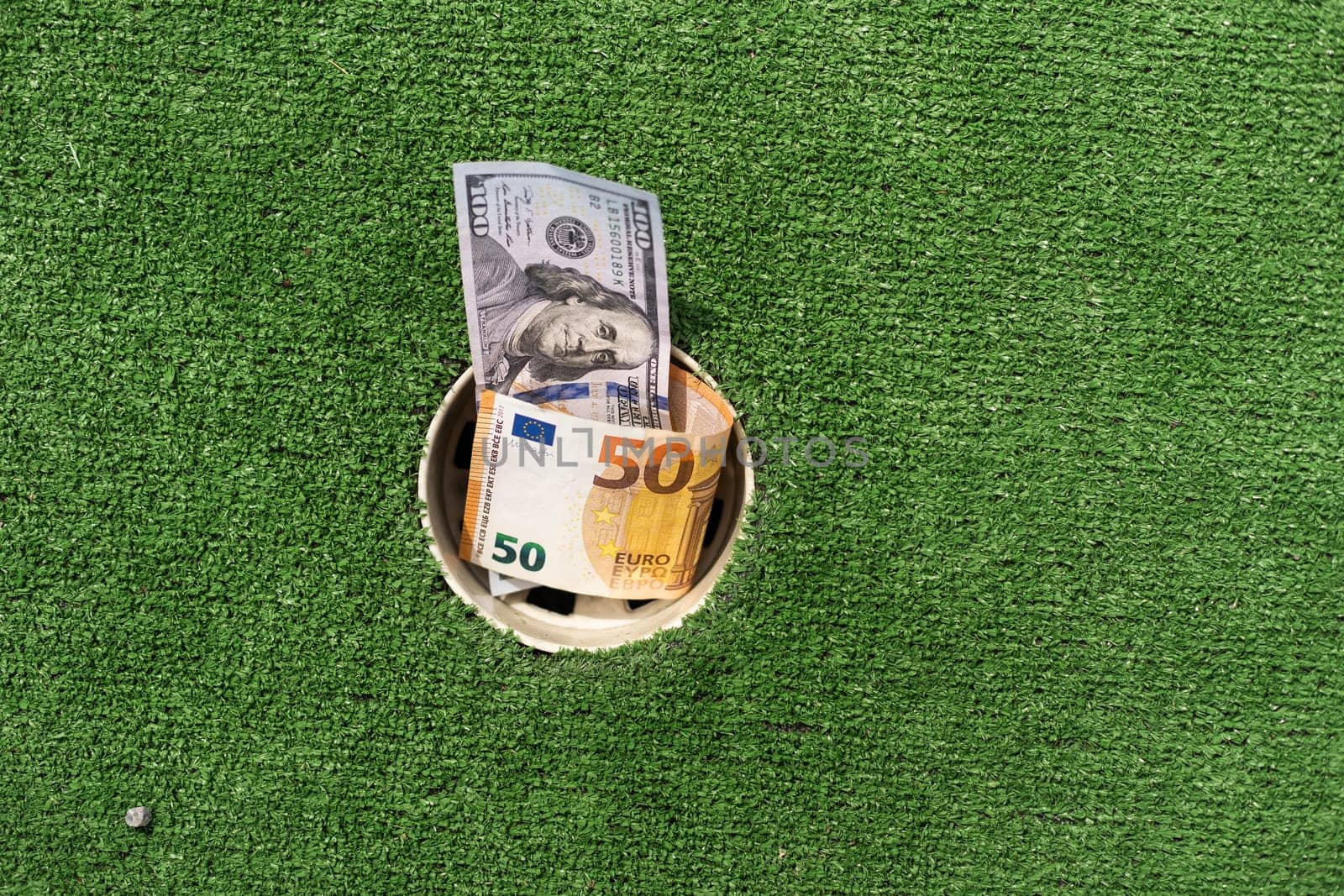 Mini Golf club, money on the artificial grass by Andelov13