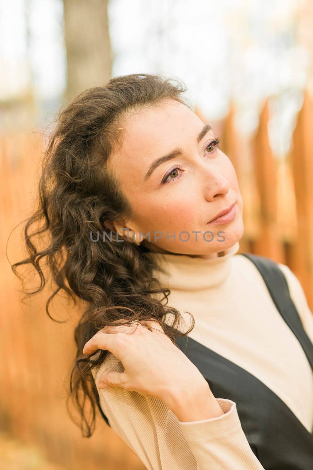 Autumn portrait of a beautiful happy curly woman in fall season. Millennial generation female. Natural beauty concept by Satura86