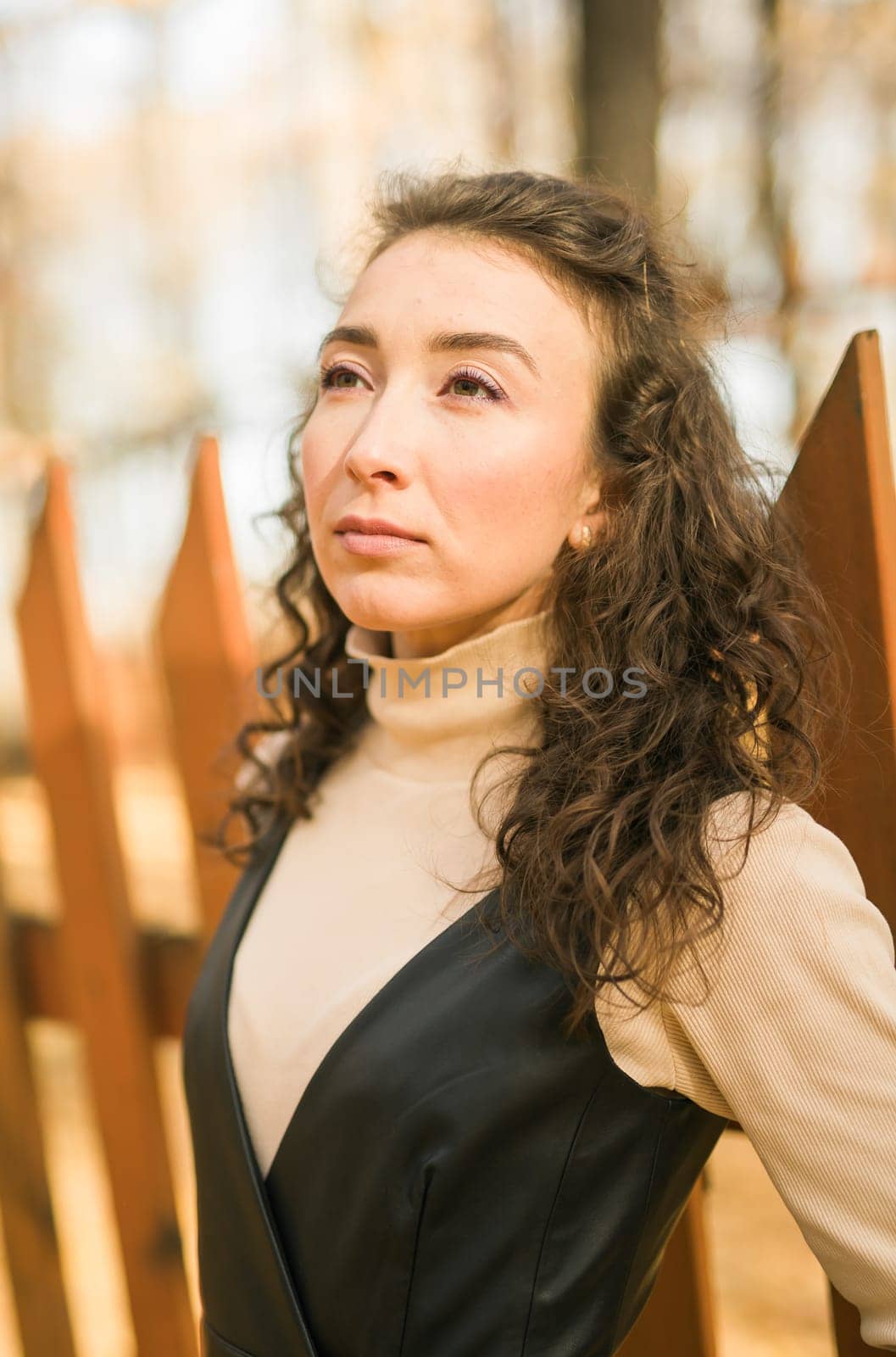 Autumn portrait of a beautiful happy curly woman in fall season. Millennial generation female. Natural beauty concept by Satura86