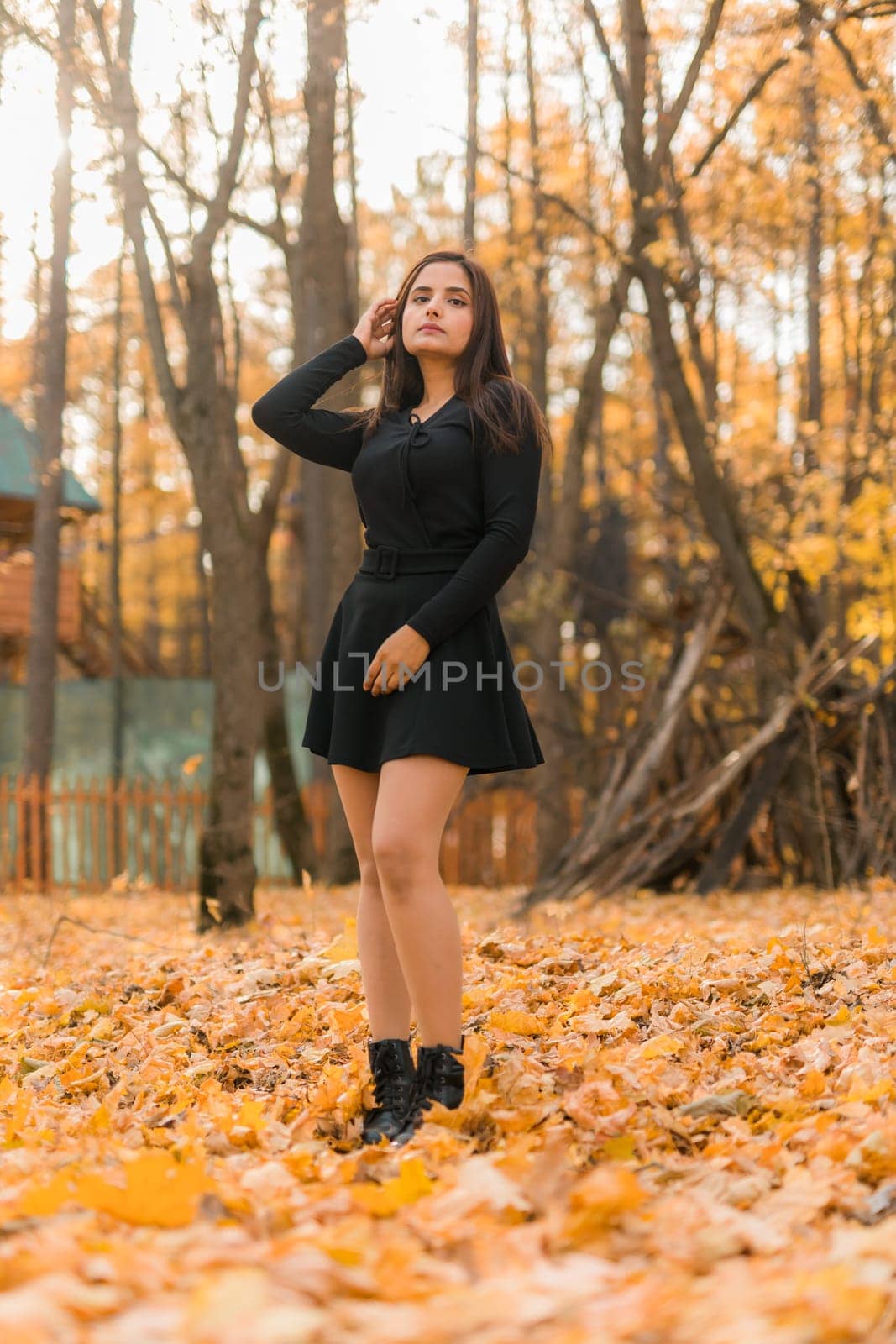 Close up portrait of pretty indian young woman enjoying warm autumn sunny day vacation outdoors. Generation z and gen z concept. Fall Season.