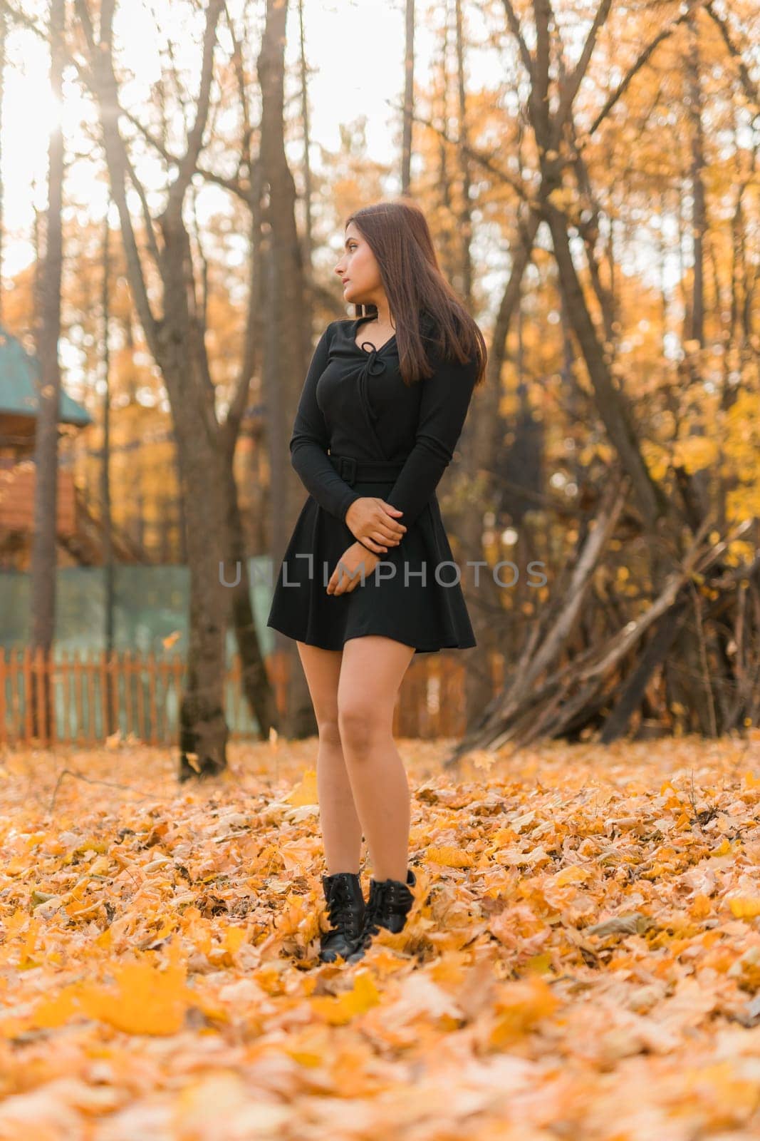 Close up portrait of pretty indian young woman enjoying warm autumn sunny day vacation outdoors. Generation z and gen z concept. Fall Season.