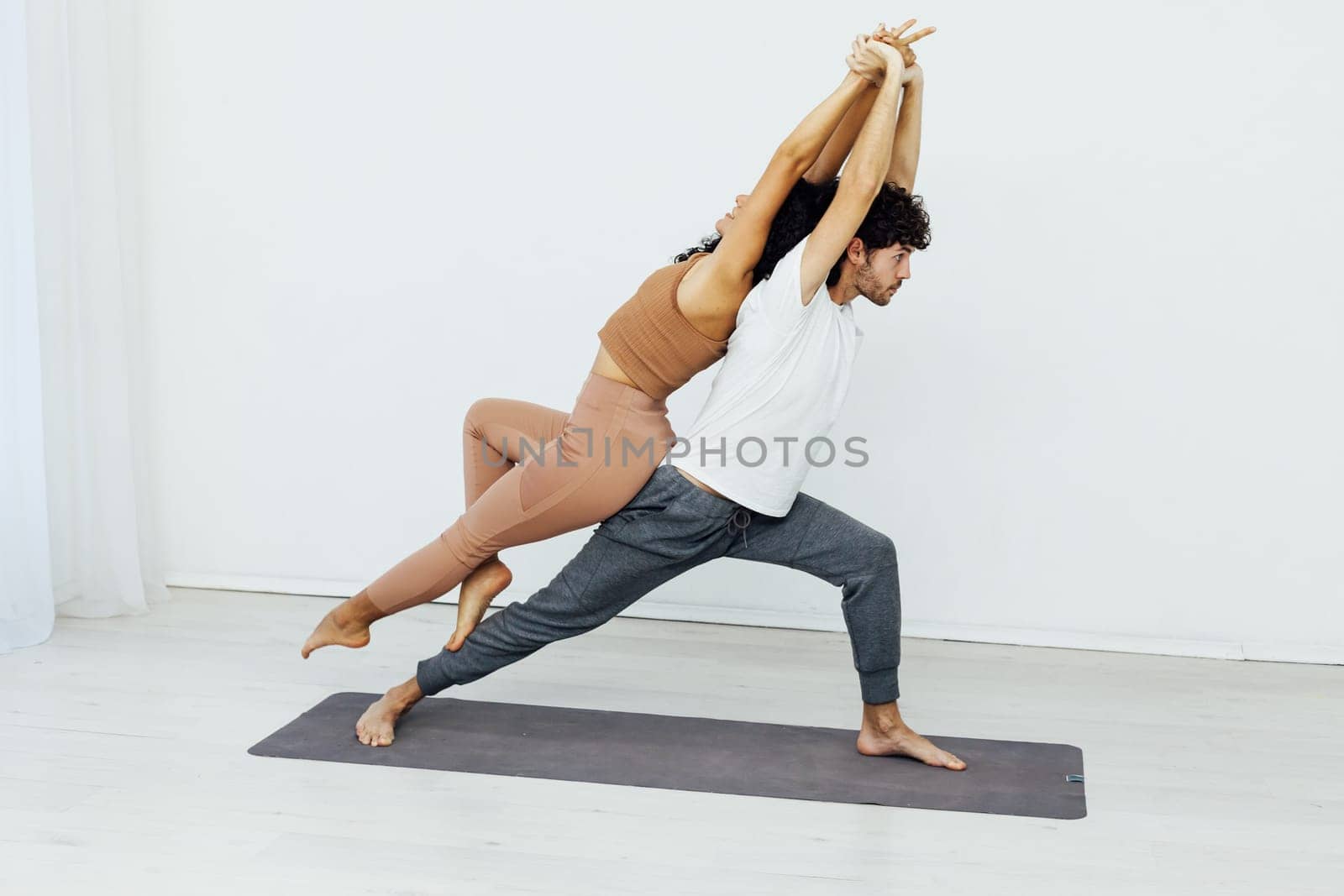 couple meditating together, sitting back to back