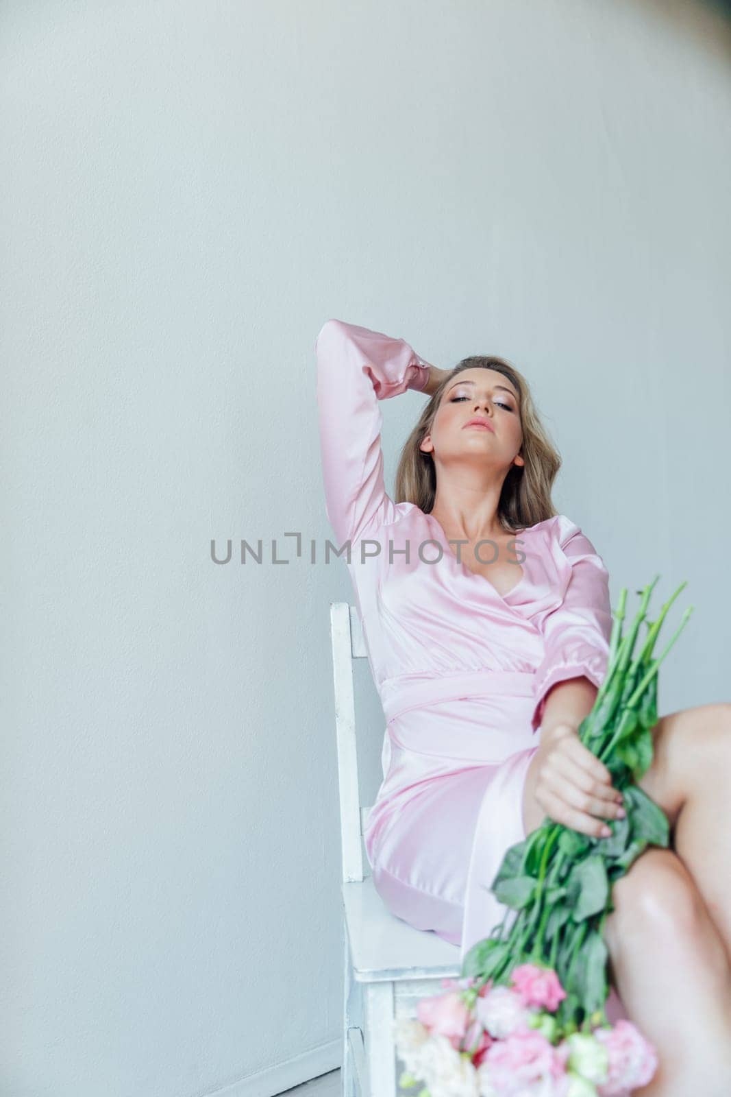 woman in pink dress with bouquet of flowers