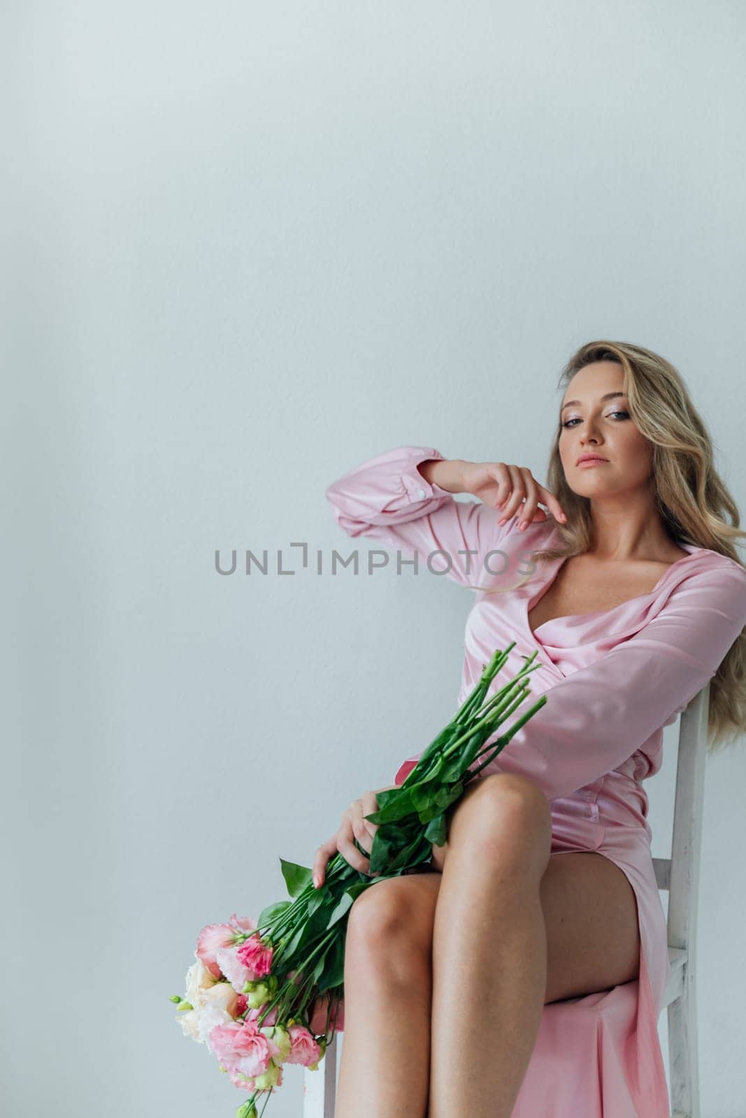 woman in pink dress with bouquet of flowers