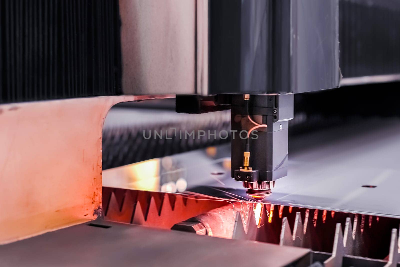 Scene close up, laser cutting machine cuts a metal plate. High-tech sheet metal production process using a laser cutting machine, CNC by yanik88
