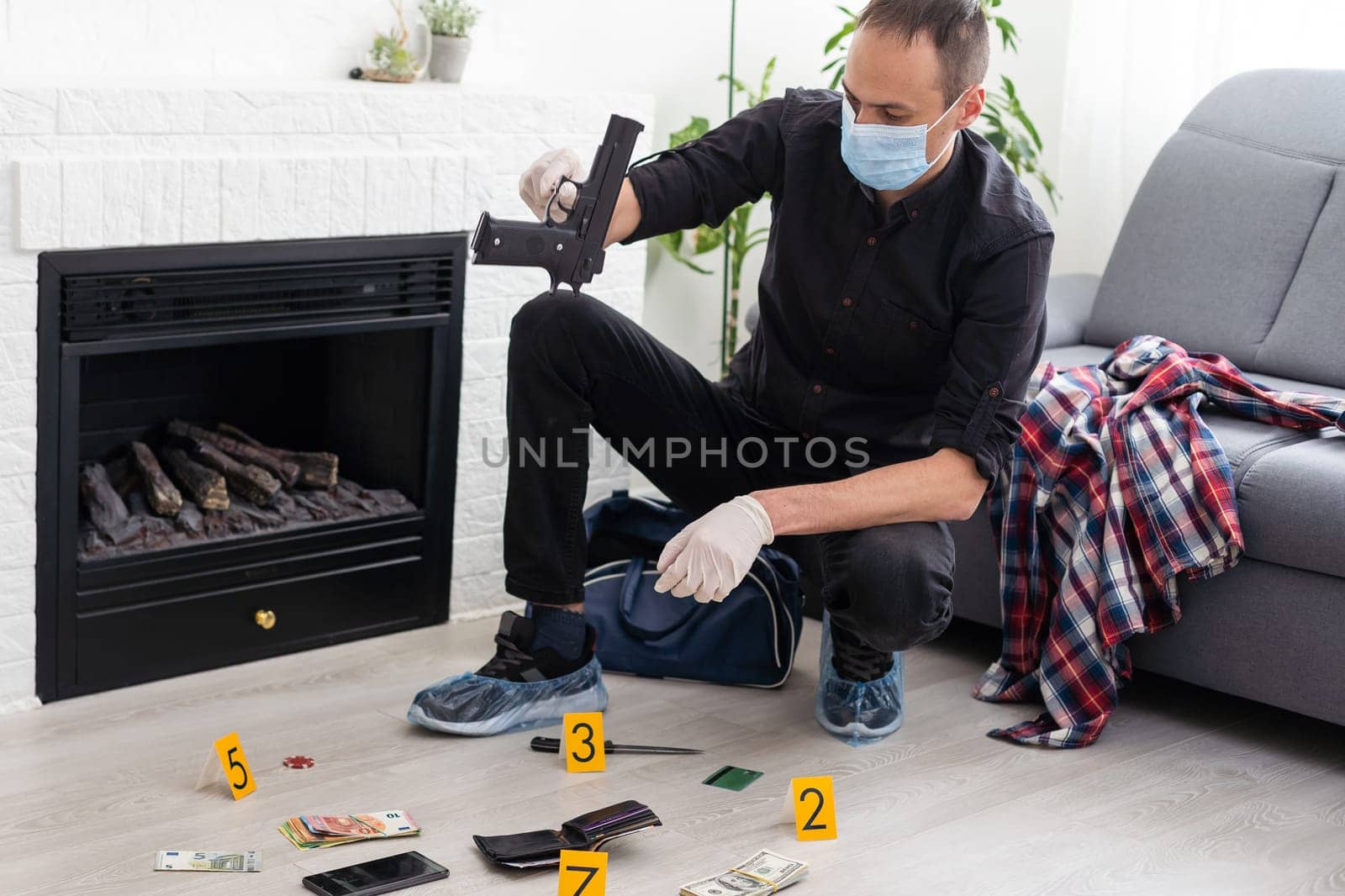 Criminological expert collecting evidence at the crime scene. High quality photo