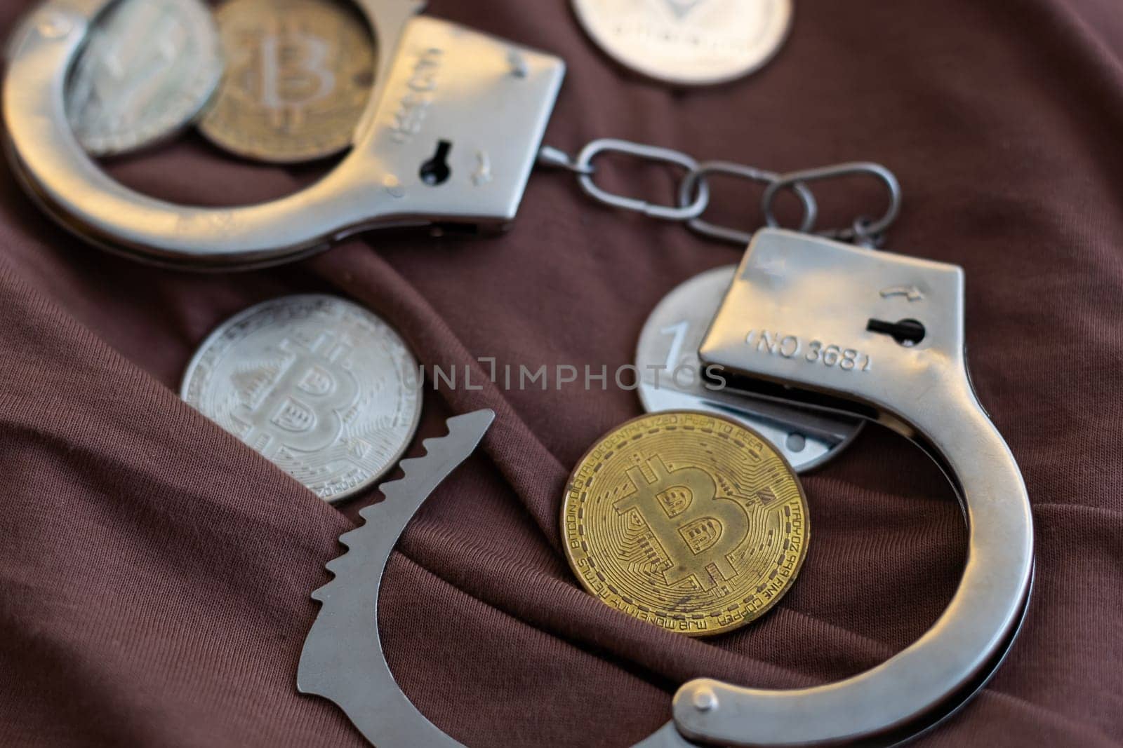 Golden bitcoin and handcuffs. Regulation and fraud of cryptocurrencies. High quality photo