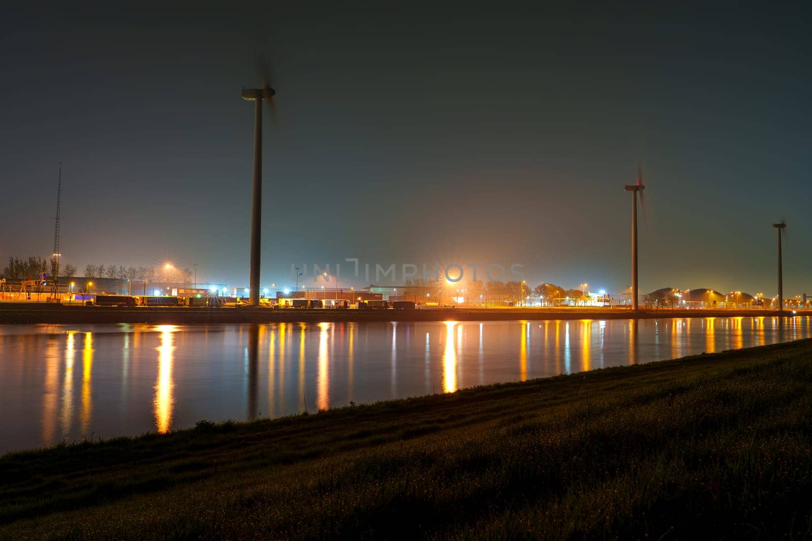 Cityscape of Rotterdam Port in Misty Night under Radiant Lights by PhotoTime