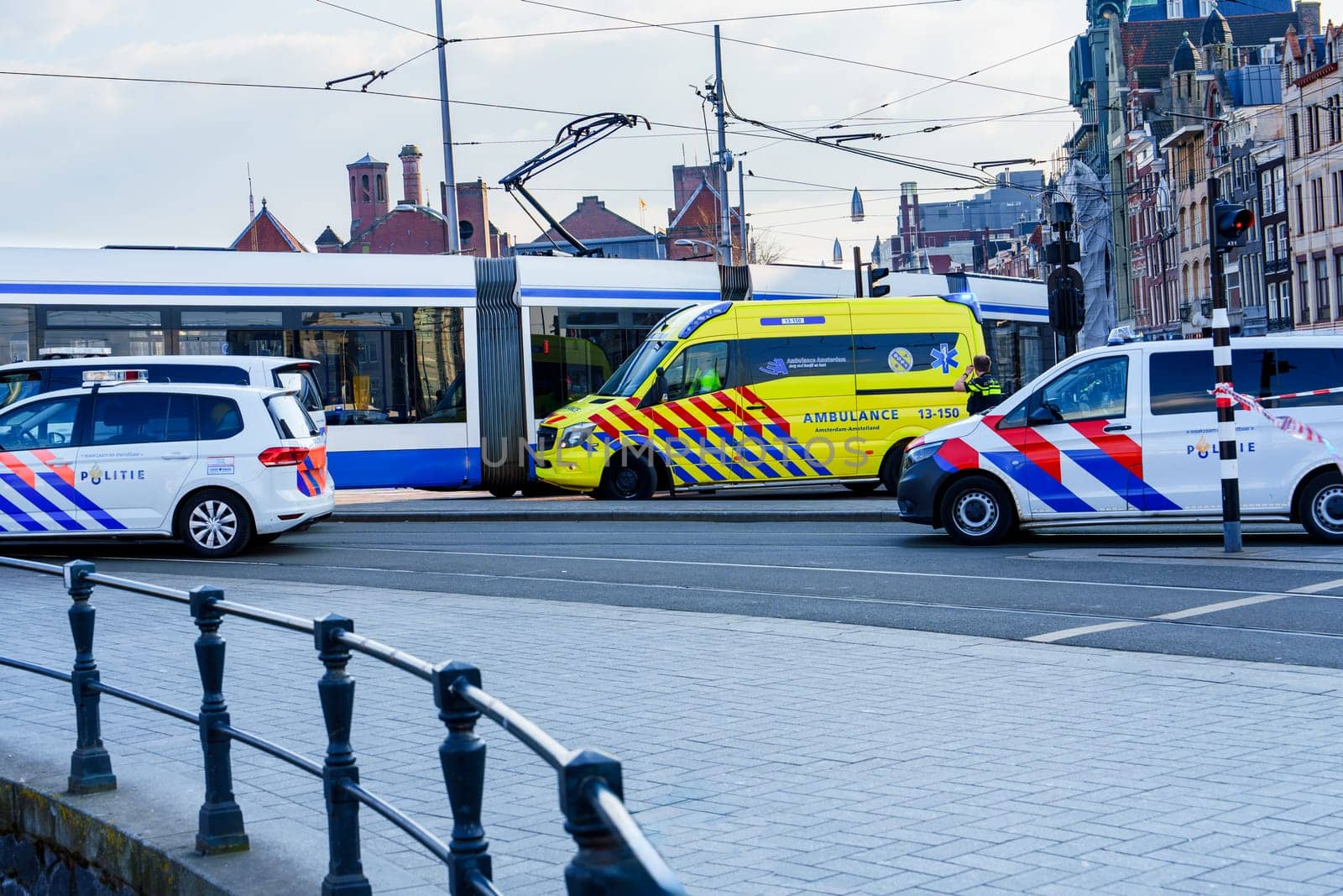Emergency situation in Amsterdam city center as a pedestrian or cyclist has been hit. The ambulances and police vehicles are on the scene to provide assistance.