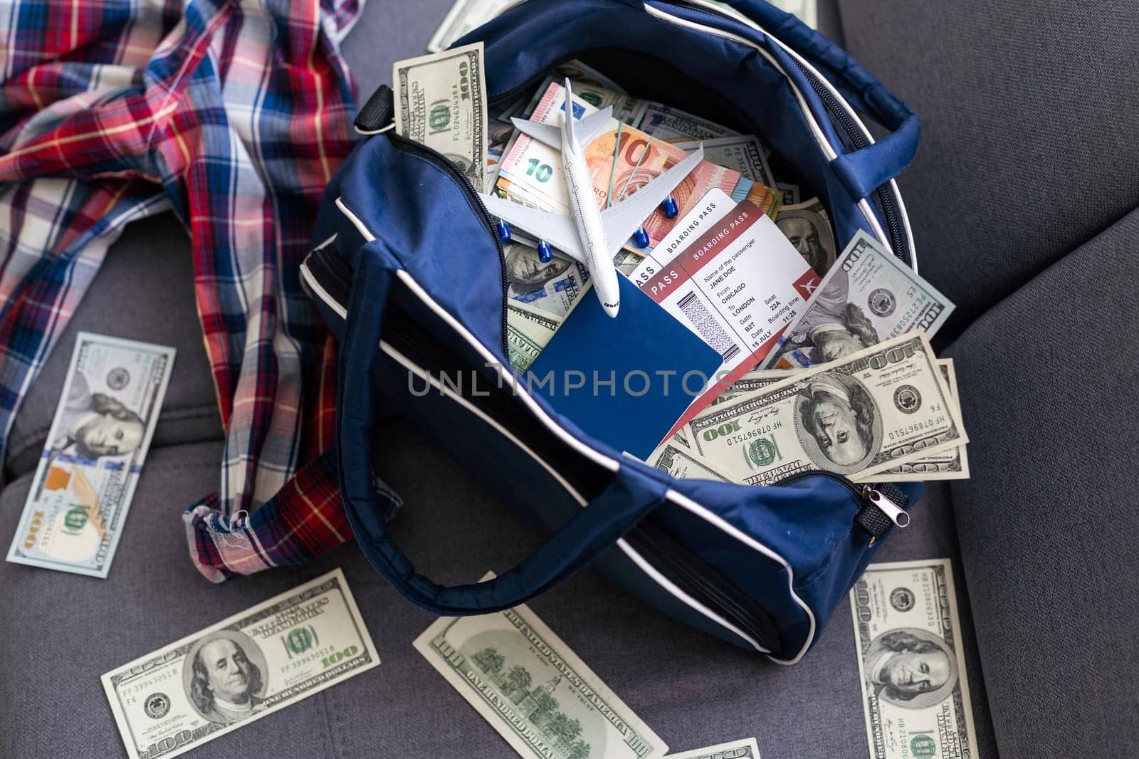 Airplane and money. Plane on the background of USA dollars. The cost of travel, air tickets and flights, financial expenses for vacation. High quality photo