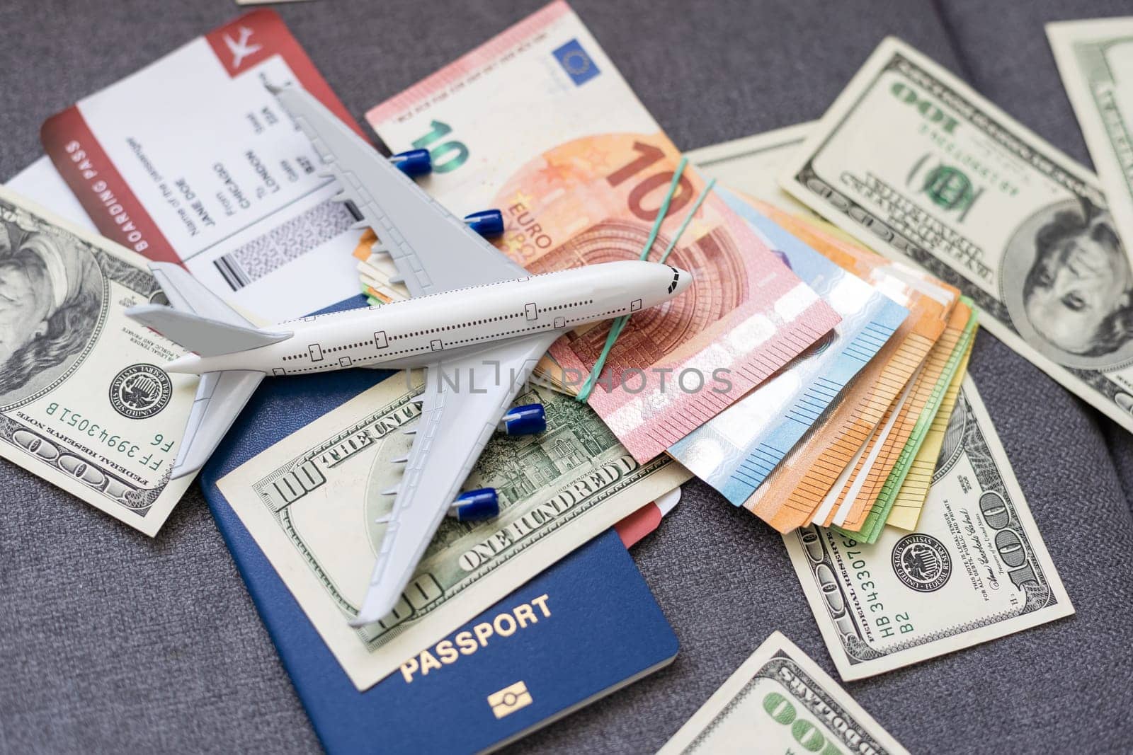 Air tickets, passports, money and toy plane on table by Andelov13