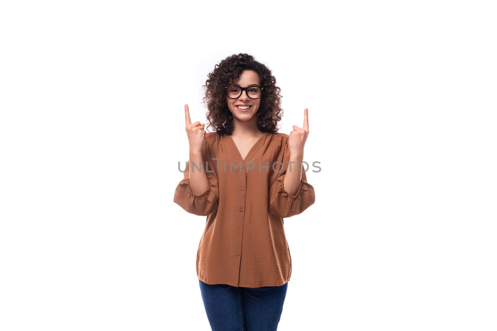 young positive cheerful slender woman with curls dressed in a brown blouse by TRMK