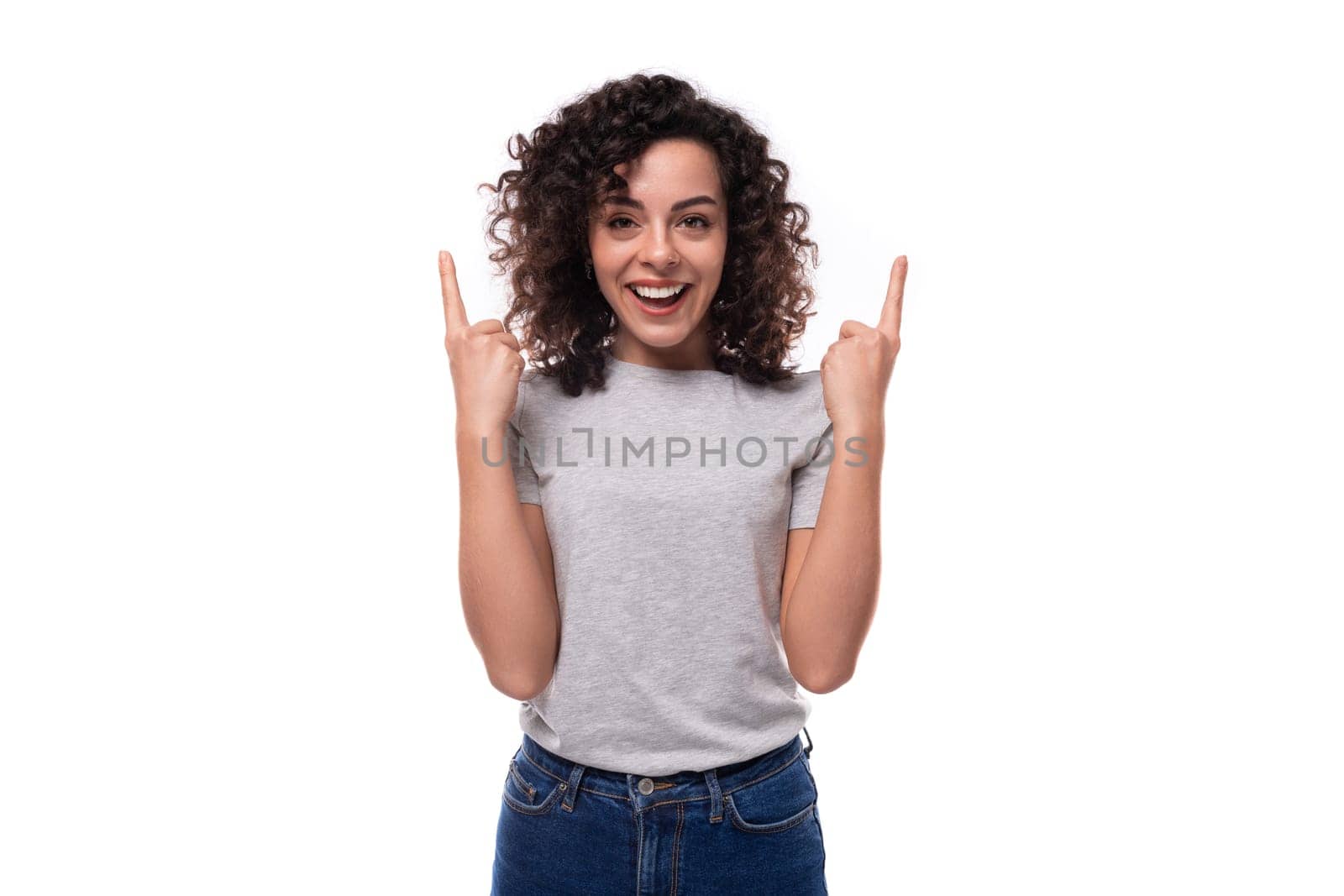 young slender brunette curly woman is dressed in a gray basic corporate color t-shirt. clothing identity and branding concept by TRMK
