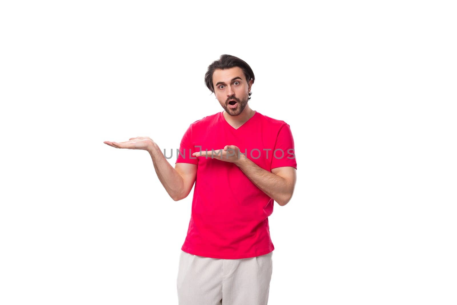 young man with black hair in a red t-shirt points empty space with his hand by TRMK