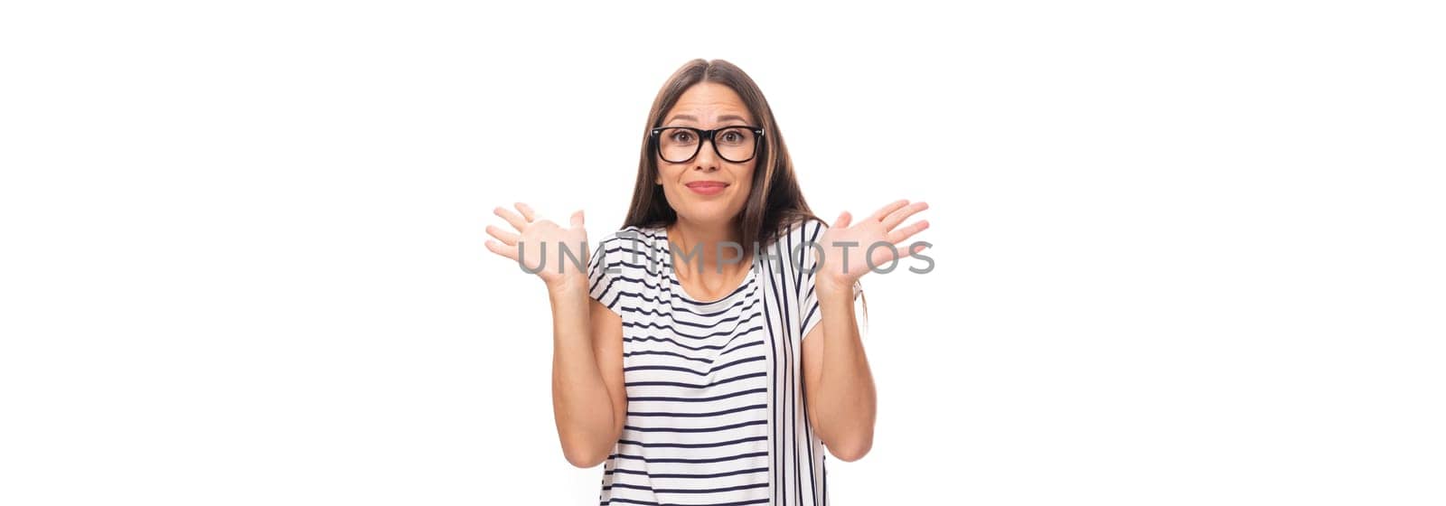 30 year old surprised brunette model woman dressed in a striped t-shirt on a wide white background with copy space by TRMK