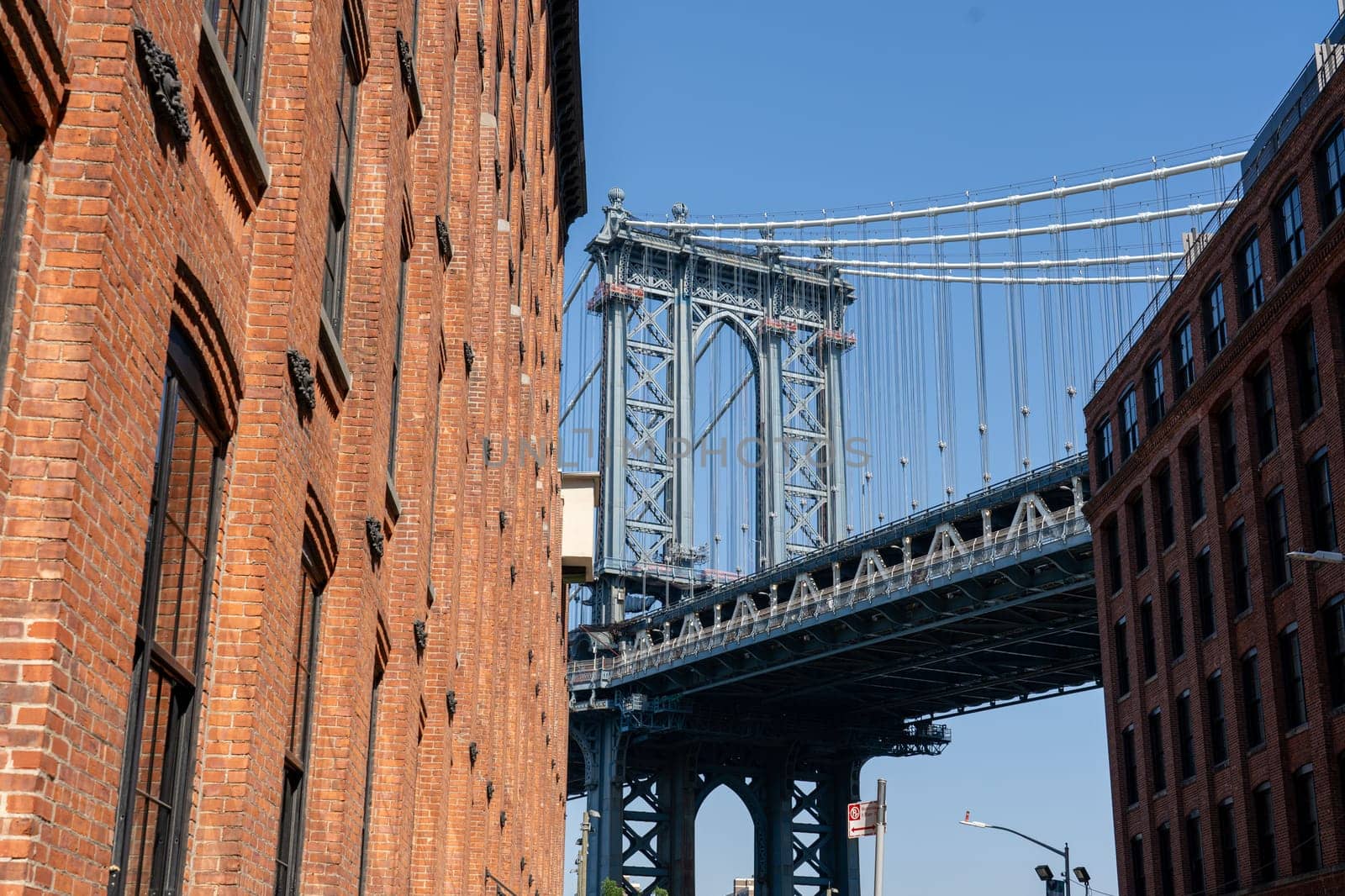 New York, United States of America - September 22, 2019: Pillar of Manhattan Bridge as seen from an alley in Dumbo district in Brooklyn.