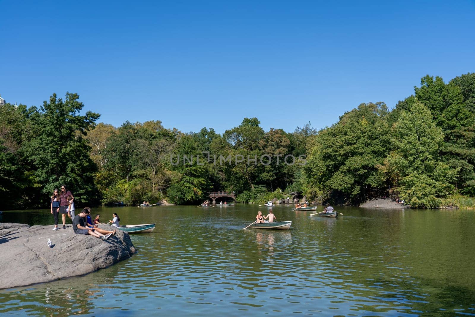 New York City, USA - September 21, 2019: People in rowboats on The Lake in Central Park.