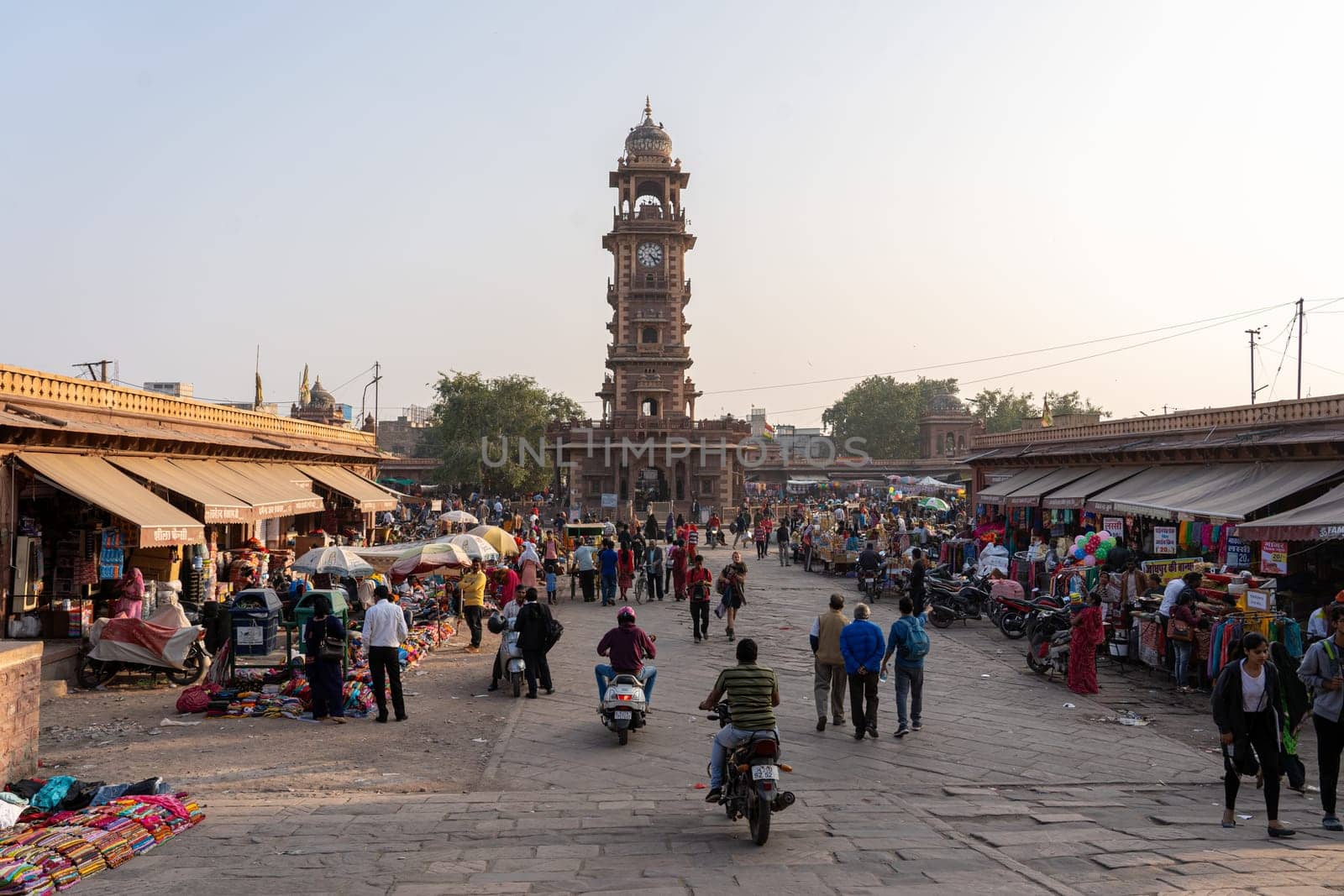 Jodhpur, India - Decembe 8, 2019: The clock tower and people at Sardar Market in the historic city centre.
