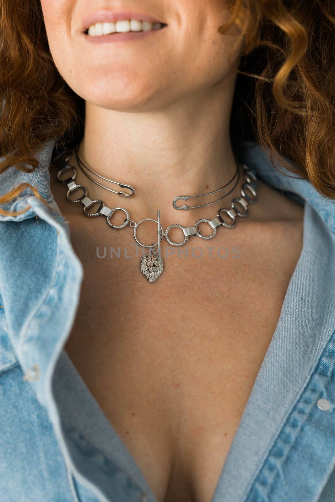 Close-up woman wearing beautiful luxury big necklace. Handmade jewellery and accessories.