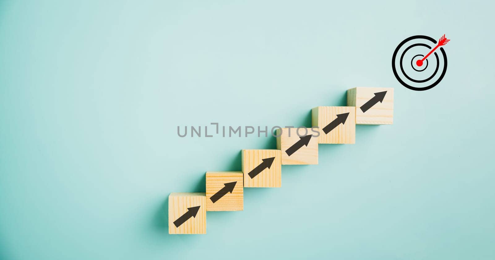 Target icon positioned on wooden blocks with upward arrows, depicting the progress. Blue background signifies business growth, while conveying concepts of profit, investment, and economic improvement.