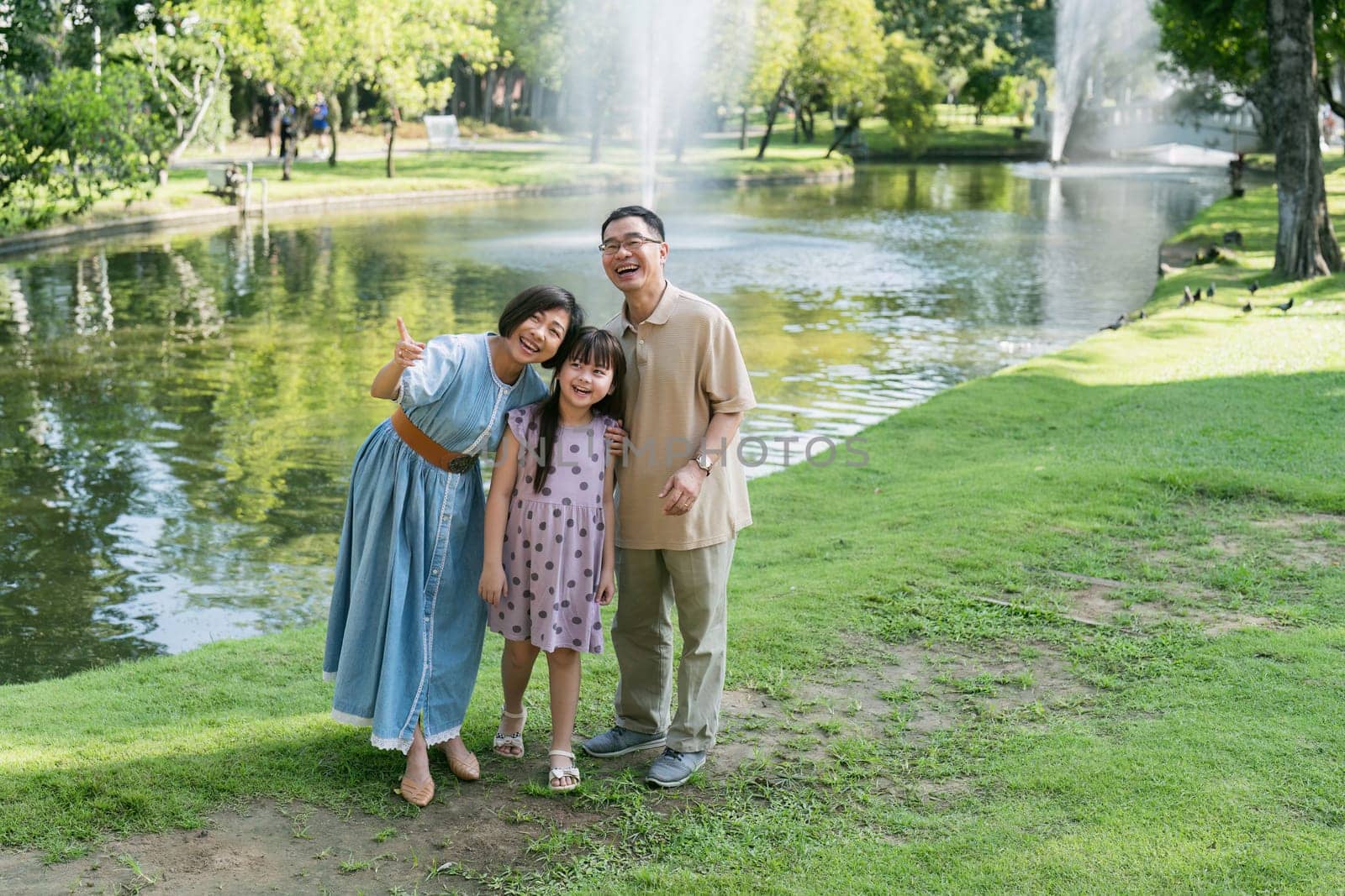 happy smiling family grandparent and grandchild picnic together outside at park by itchaznong