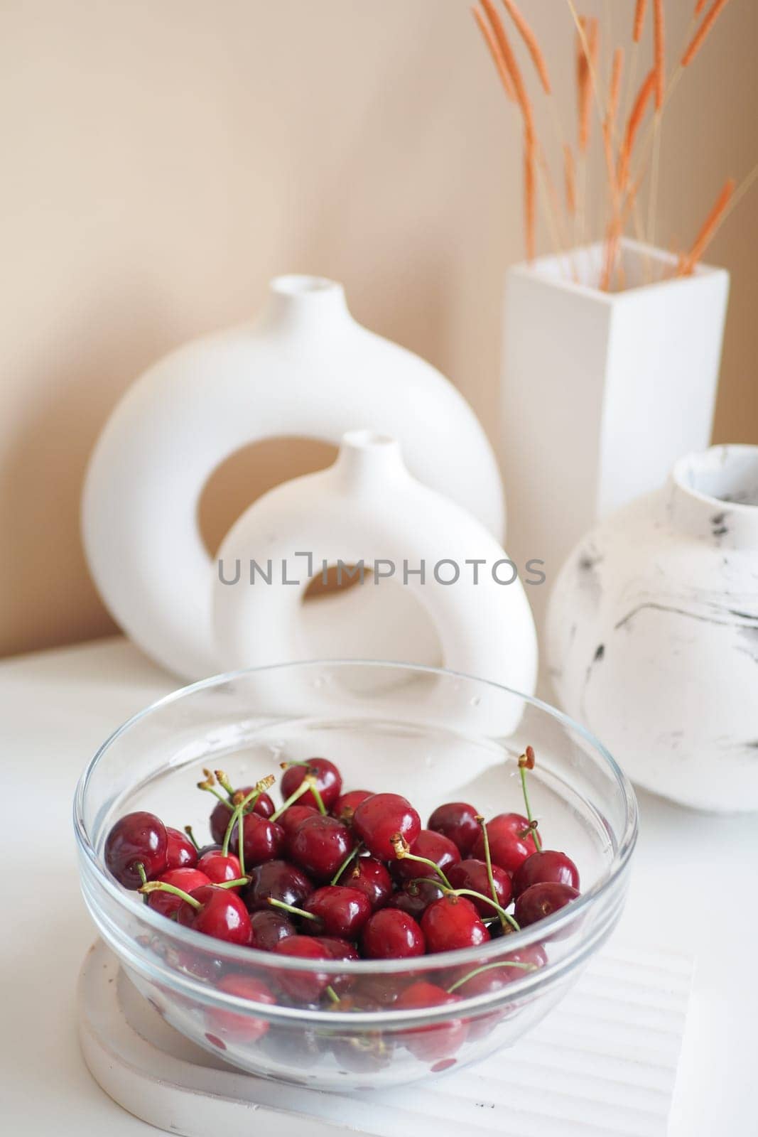 ripe fresh cherry in a bowl on table by towfiq007