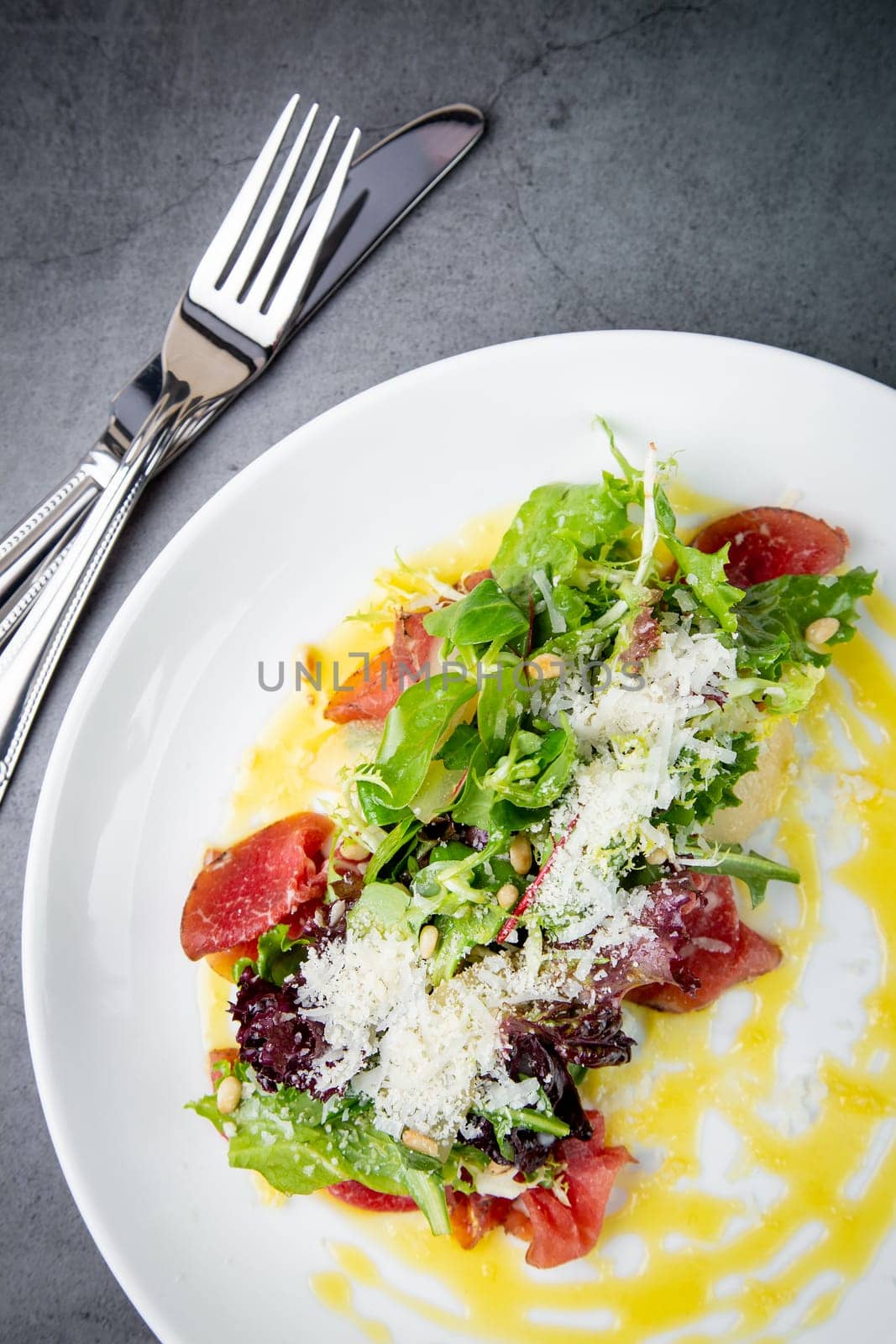 side view of salad with red fish, herbs and cheese