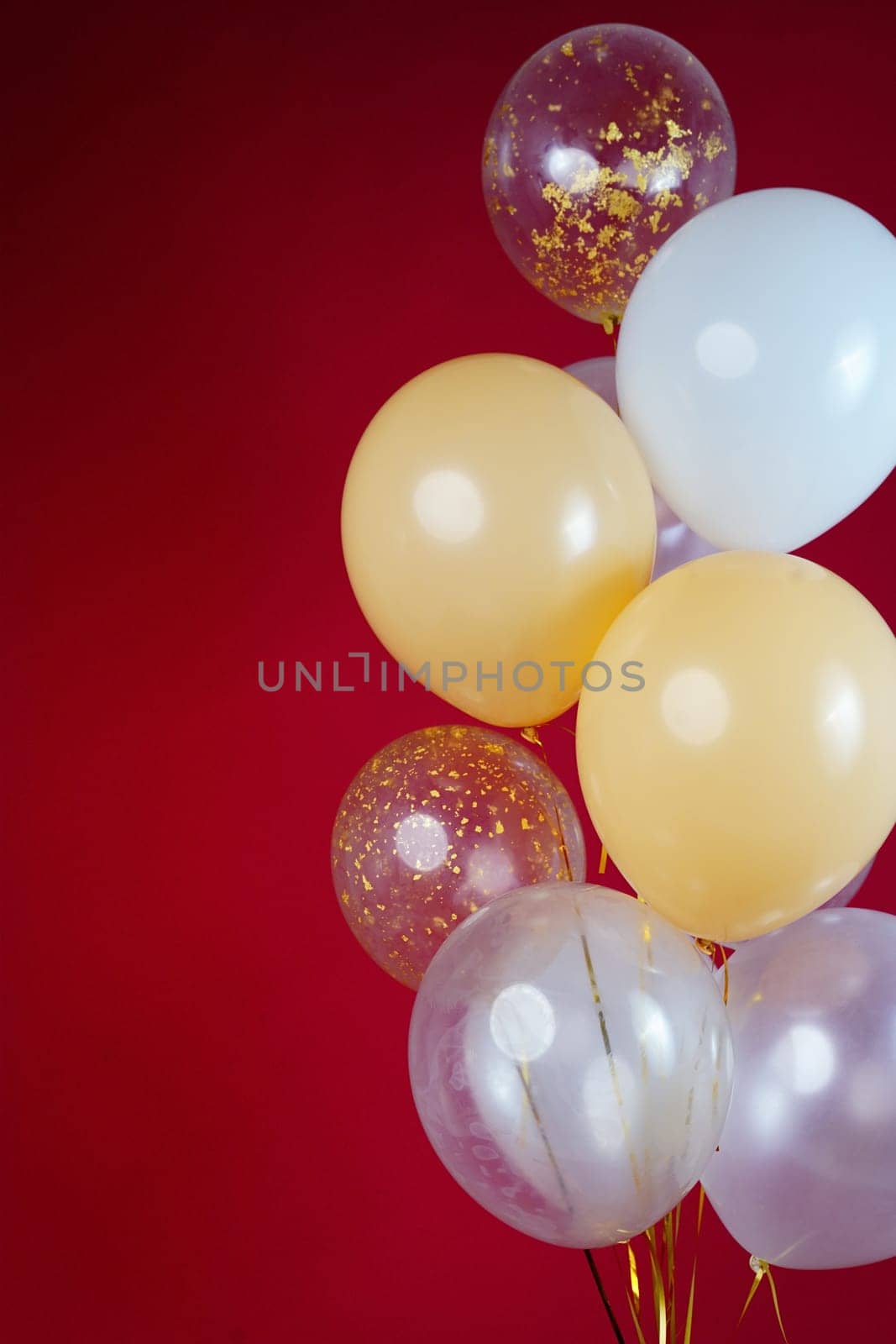 A bunch of light balloons on a red background. Vertical Photo Space for Text by tewolf