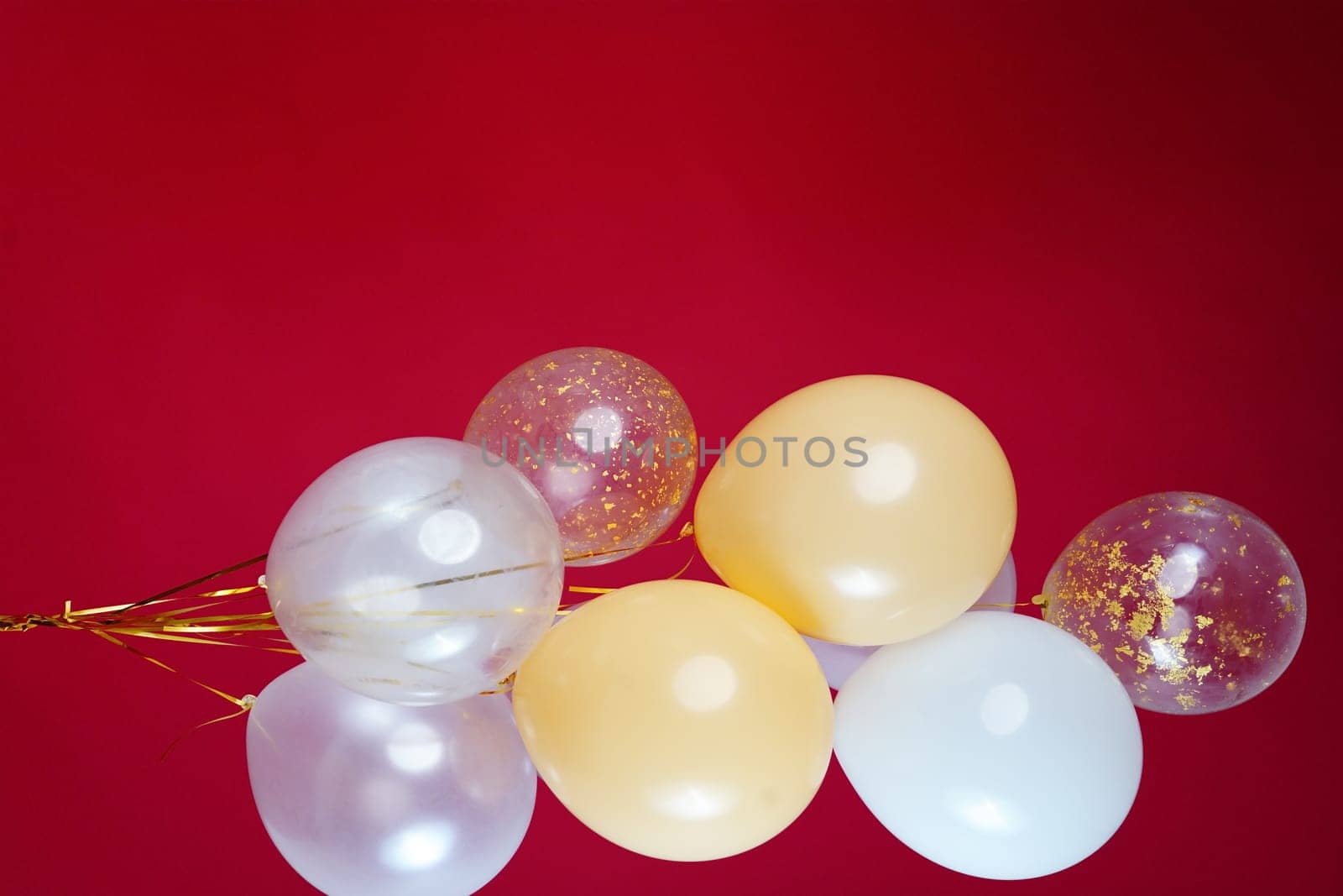 A bunch of light balloons on a red background. Vertical Photo Space for Text by tewolf