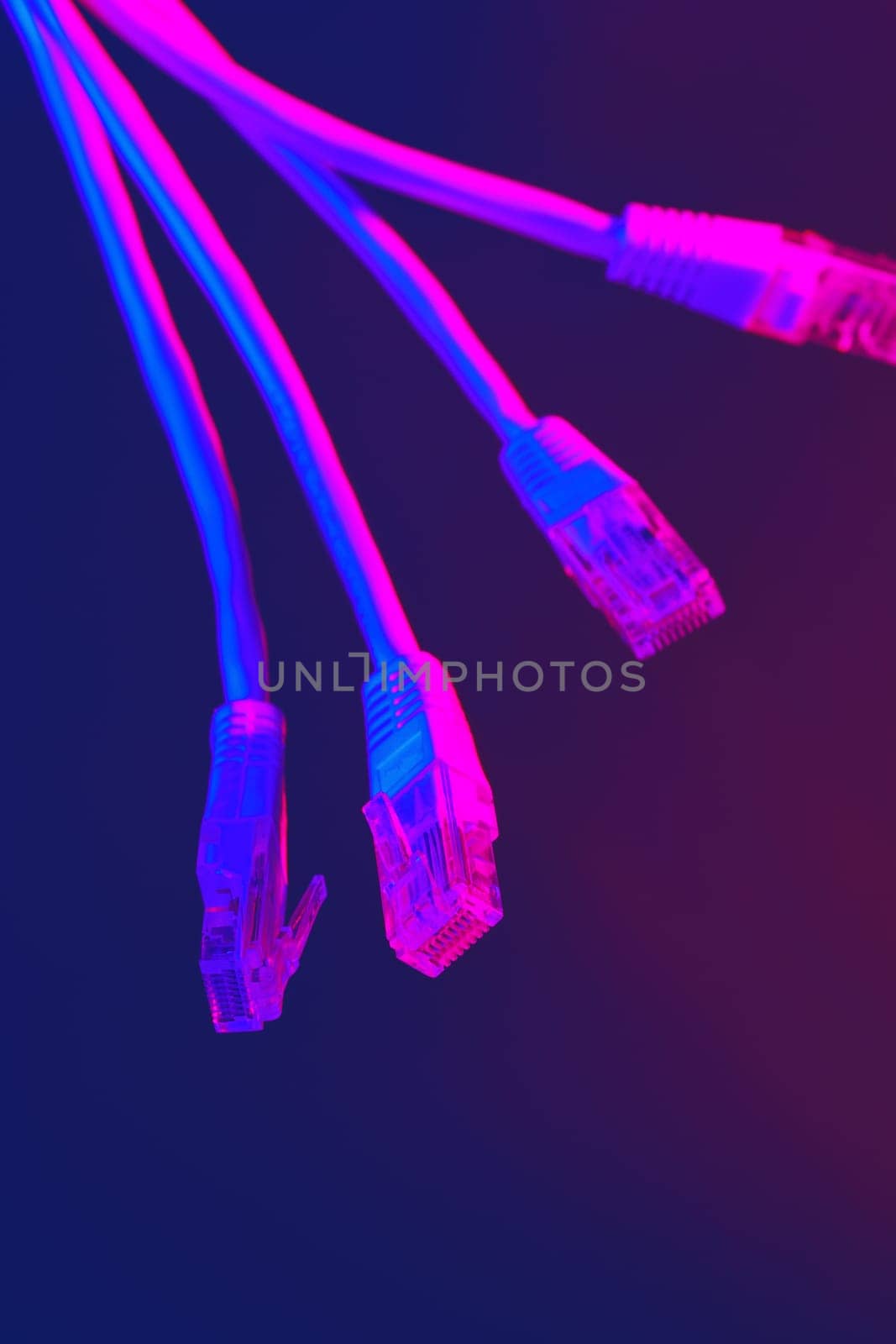 Modern technology network cable in neon light. by Fabrikasimf