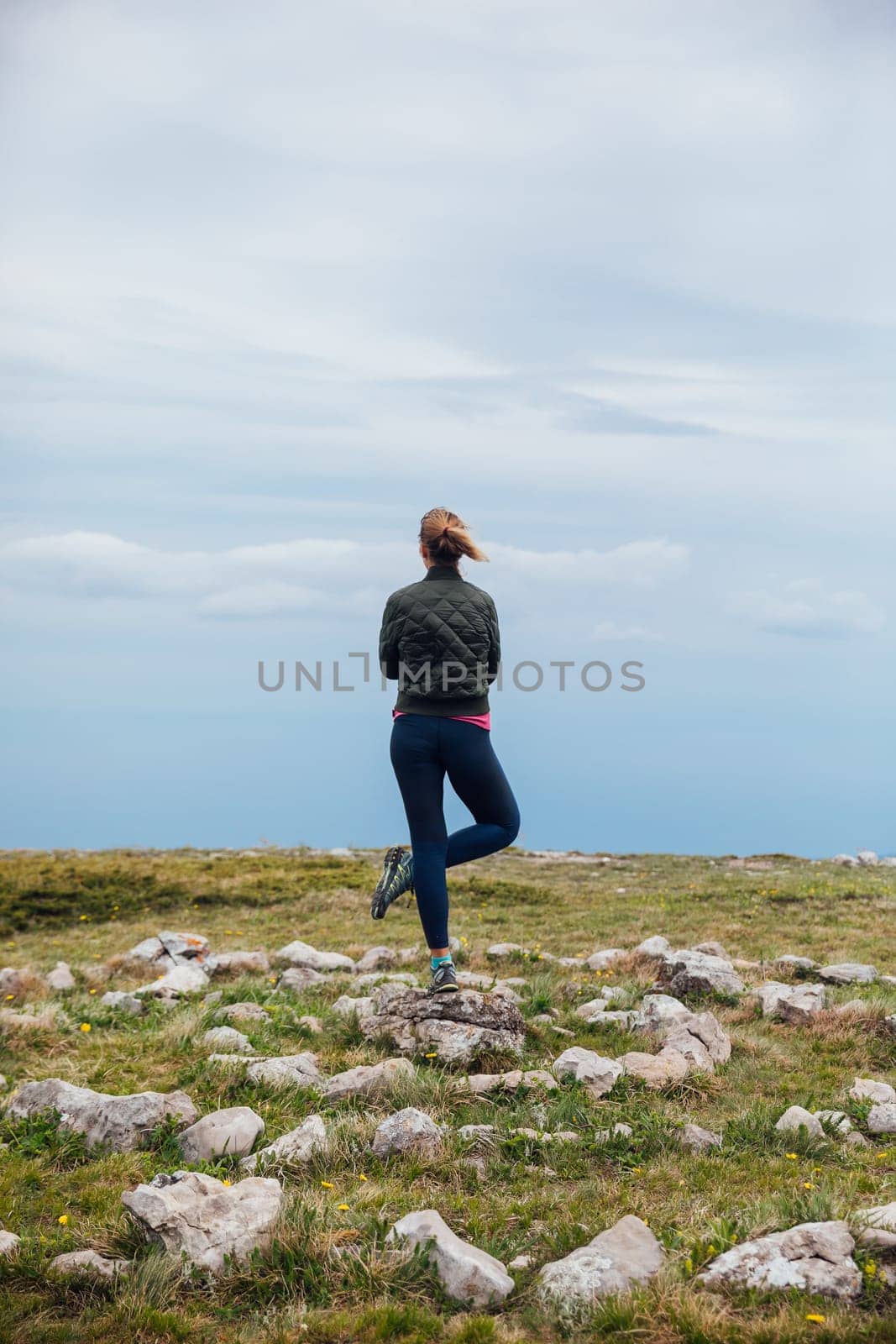 Woman doing yoga on top of Mount Asana power breathing