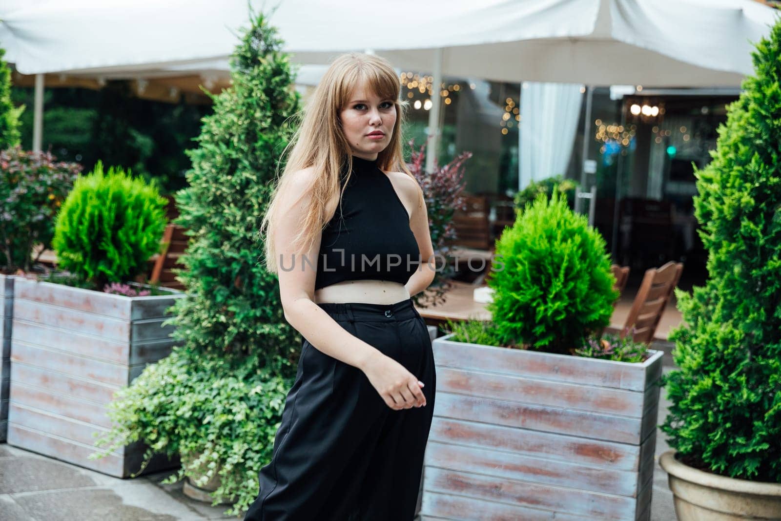 Portrait of a beautiful woman in black camsuits outdoors