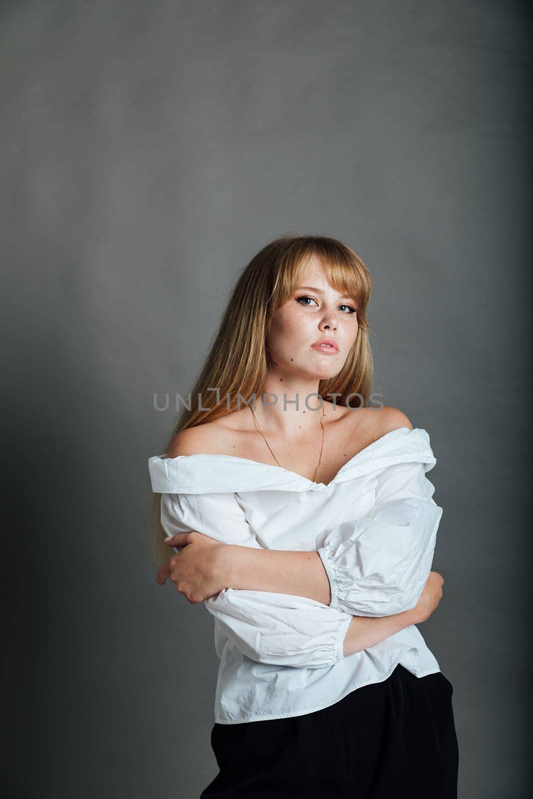 young woman in white blouse and black pants