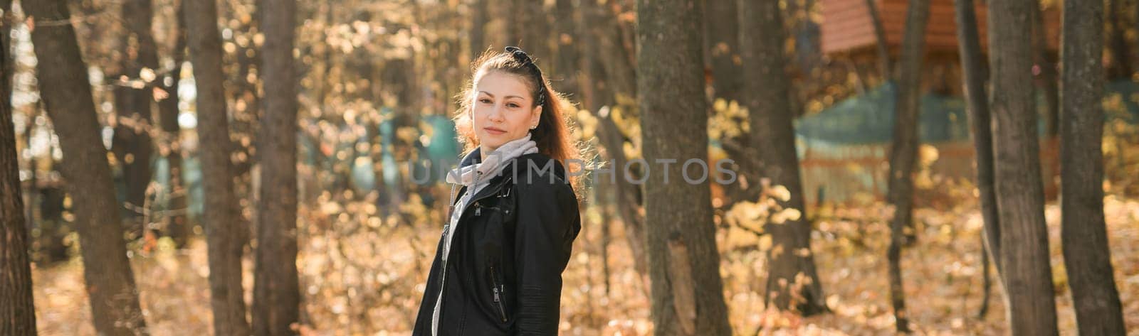 Banner Outdoor atmospheric lifestyle portrait of young beautiful young woman copy space. Warm autumn fall season. Millennial generation and youth by Satura86