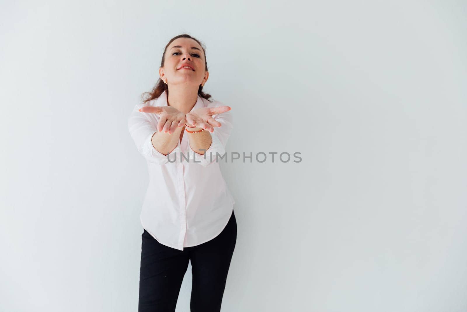 Beautiful brunette woman stretching her hands and smiling by Simakov