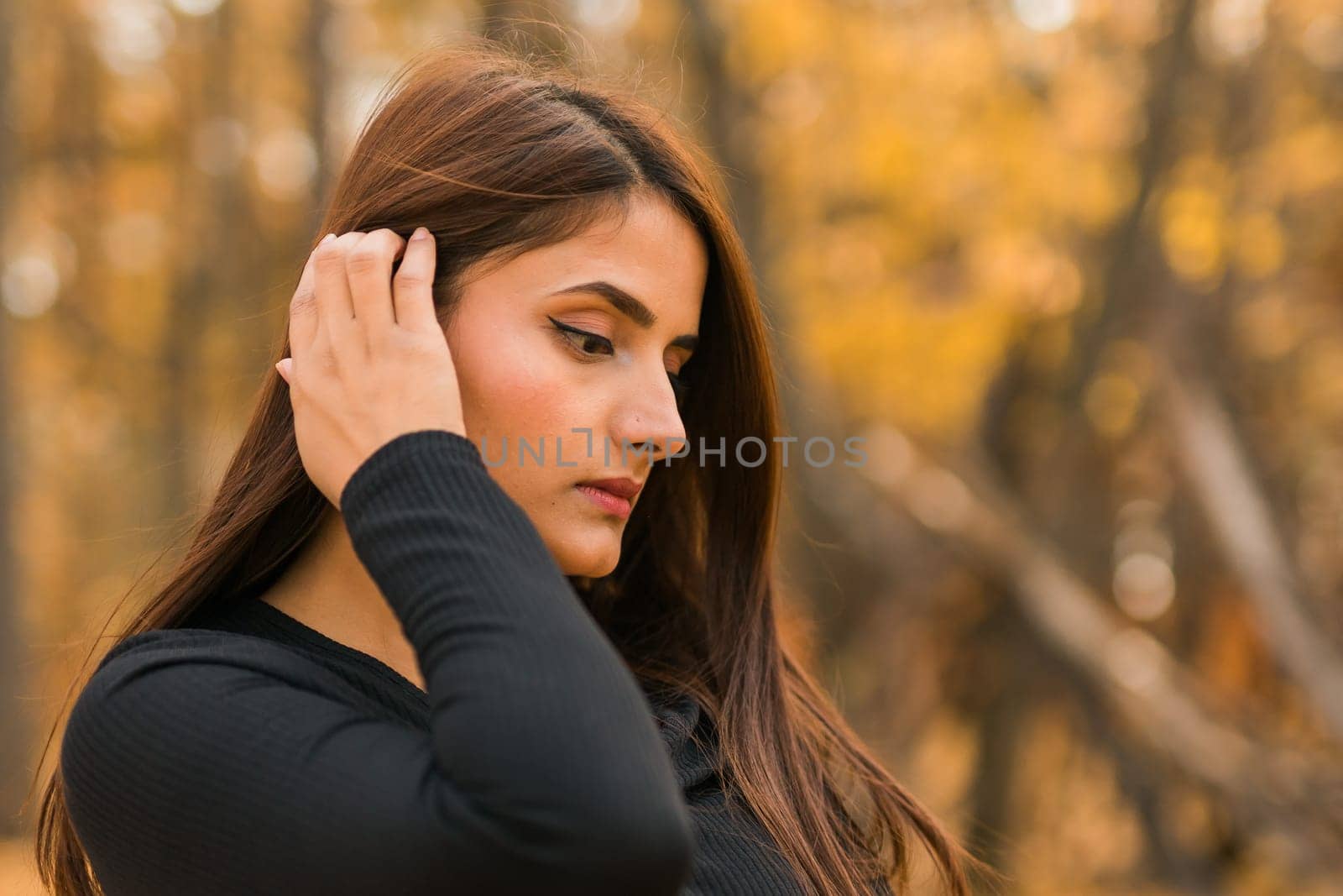 Close up portrait of pretty indian young woman enjoying warm autumn sunny day vacation outdoors copy space. Generation z and gen z concept. Fall Season by Satura86