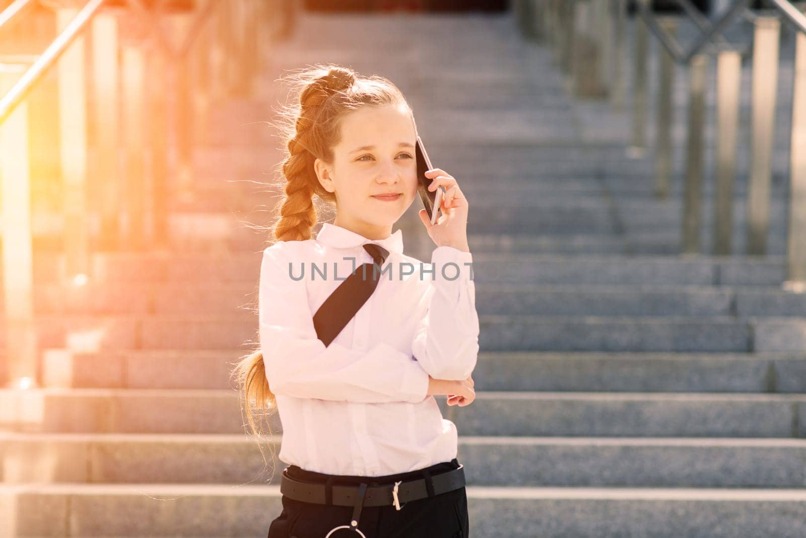Little school girl having phone talk with friend. modern life communication. Living in digital age. by Zelenin