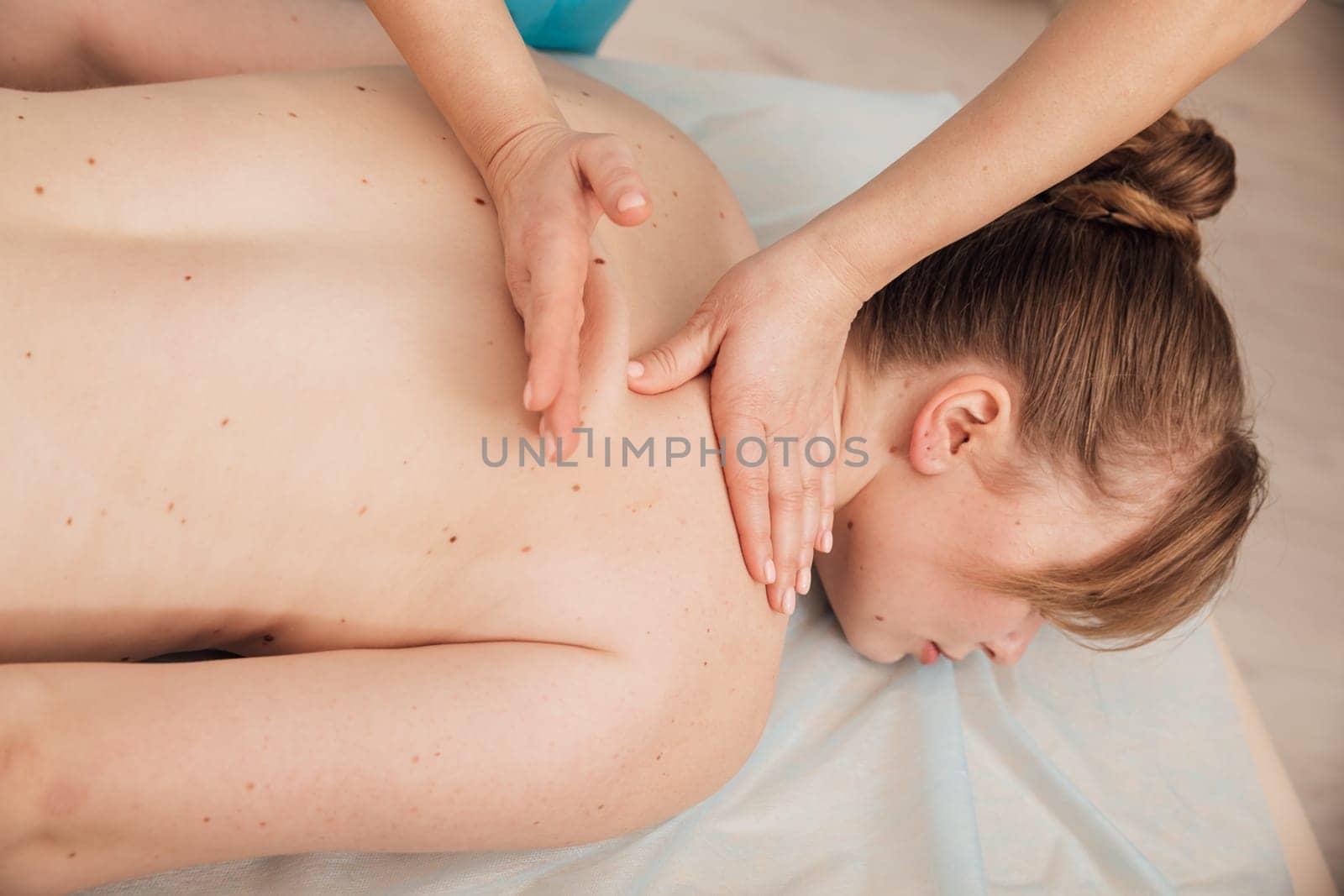 woman relaxing and having massage in a SPA.