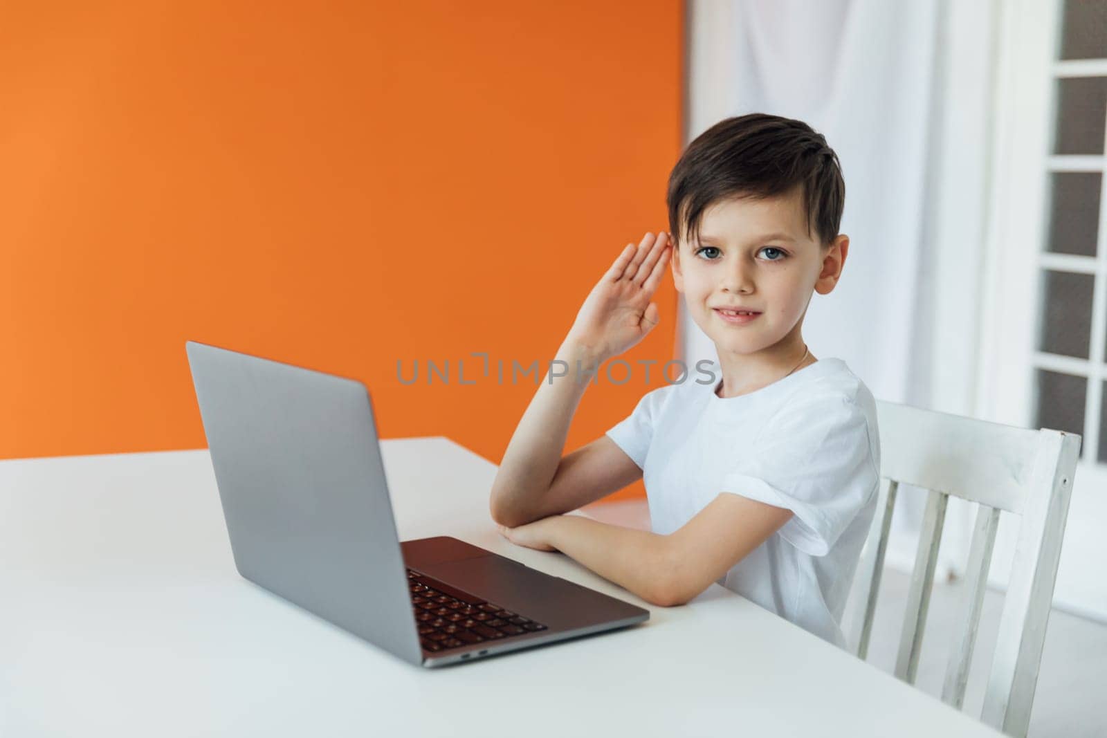 Little boy using laptop on white background