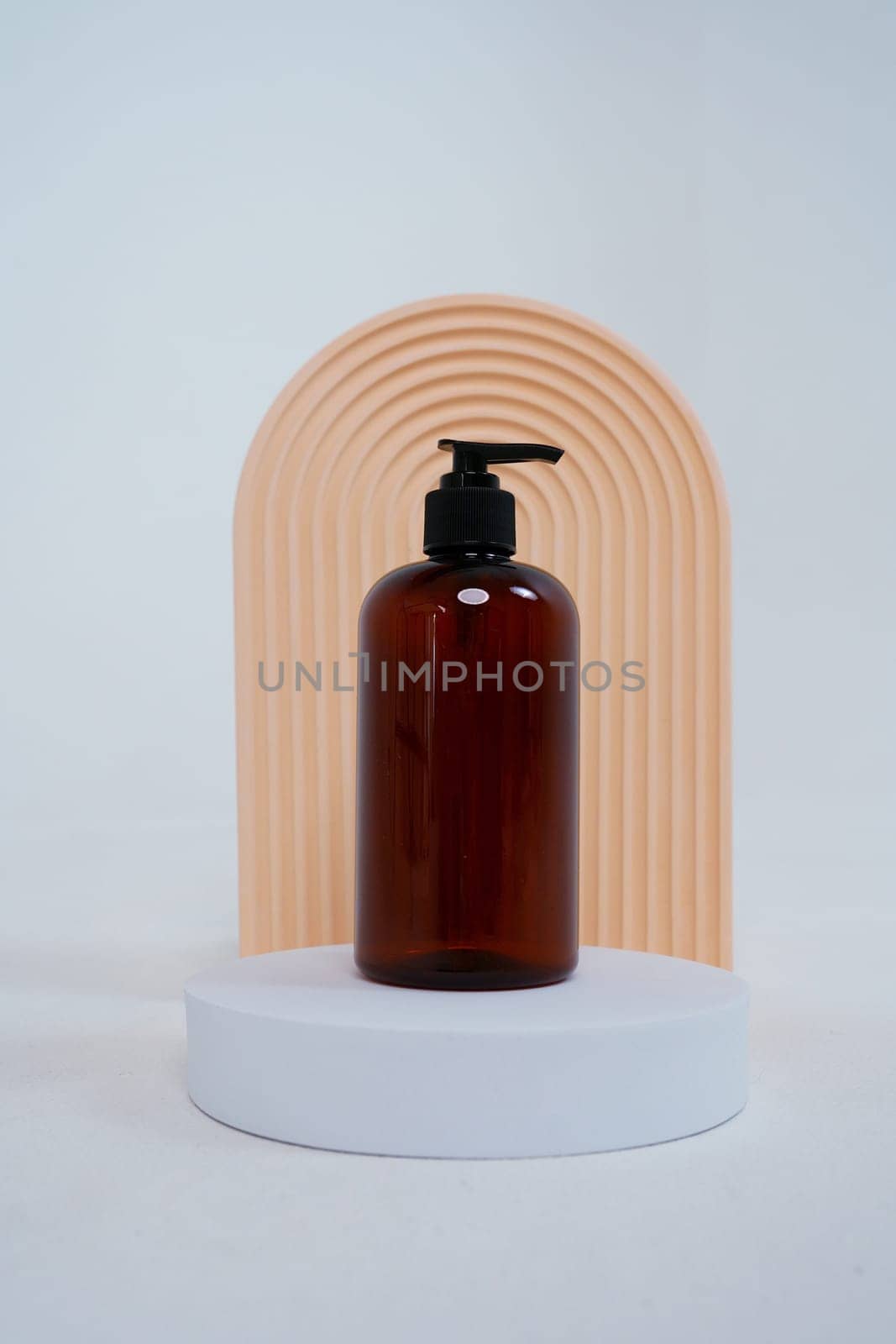 Composition with geometric shapes.body care. bottle with a dispenser, on a light gray background. Advertising concept by tewolf