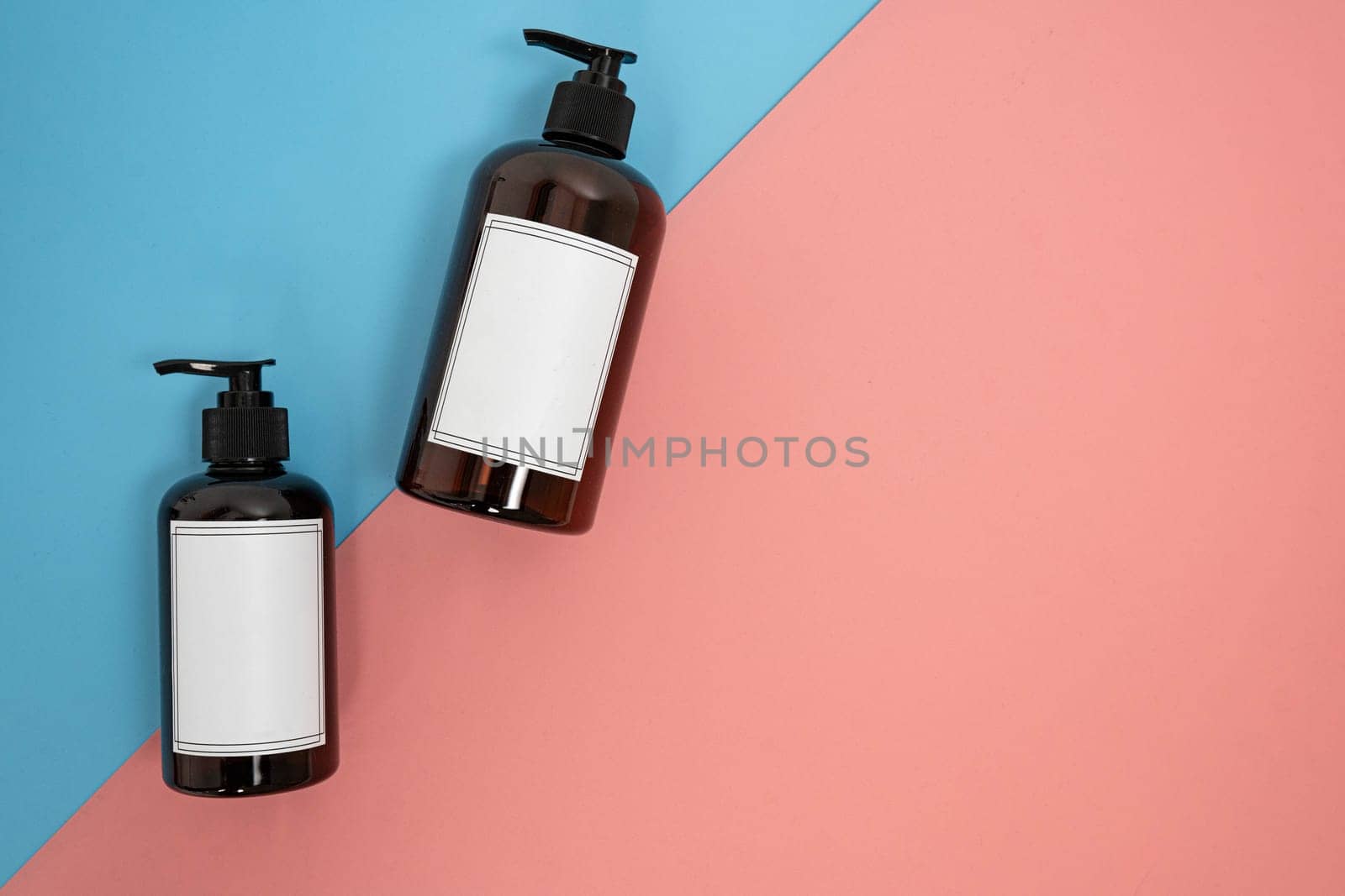 Body care. set of bottles with dispensers on a blue and pink background. Advertising concept by tewolf